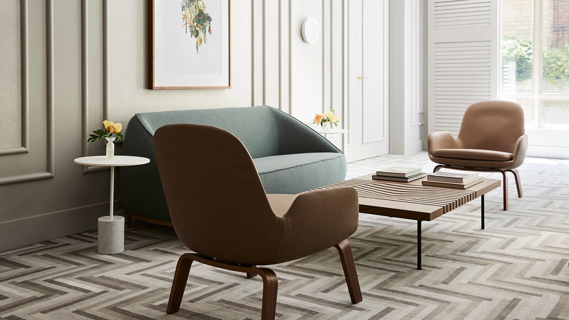 Semi-modern residential space with a mix of leather and fabric seating furniture and a wooden floor.