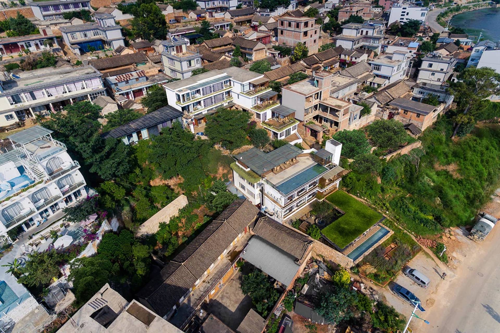 Aerial view of a densely populated urban neighborhood with various types of residential buildings and green spaces.