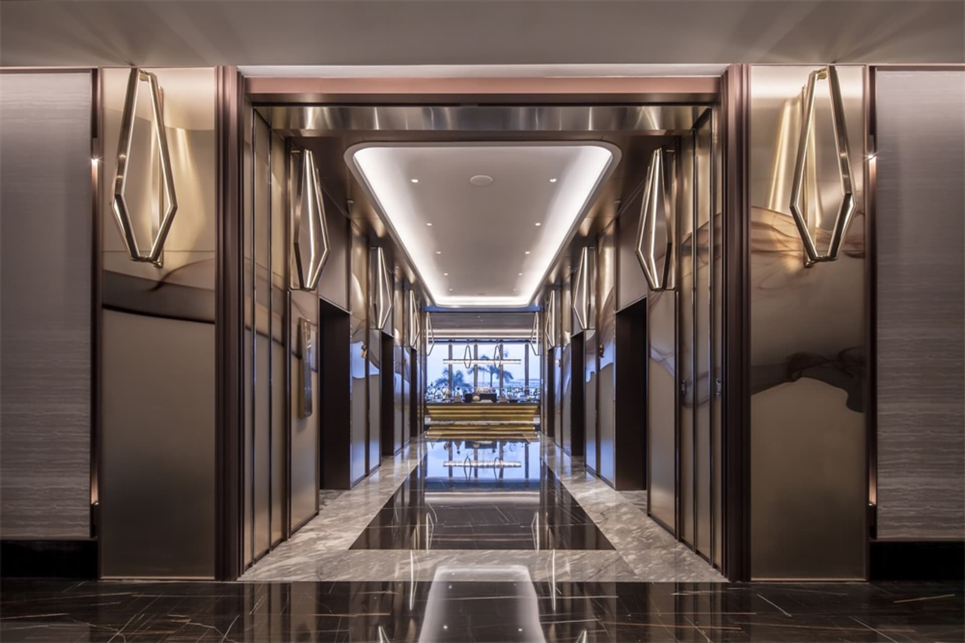 Modern interior of a fashionable hotel hallway with glass mirrors and brass handles and details
