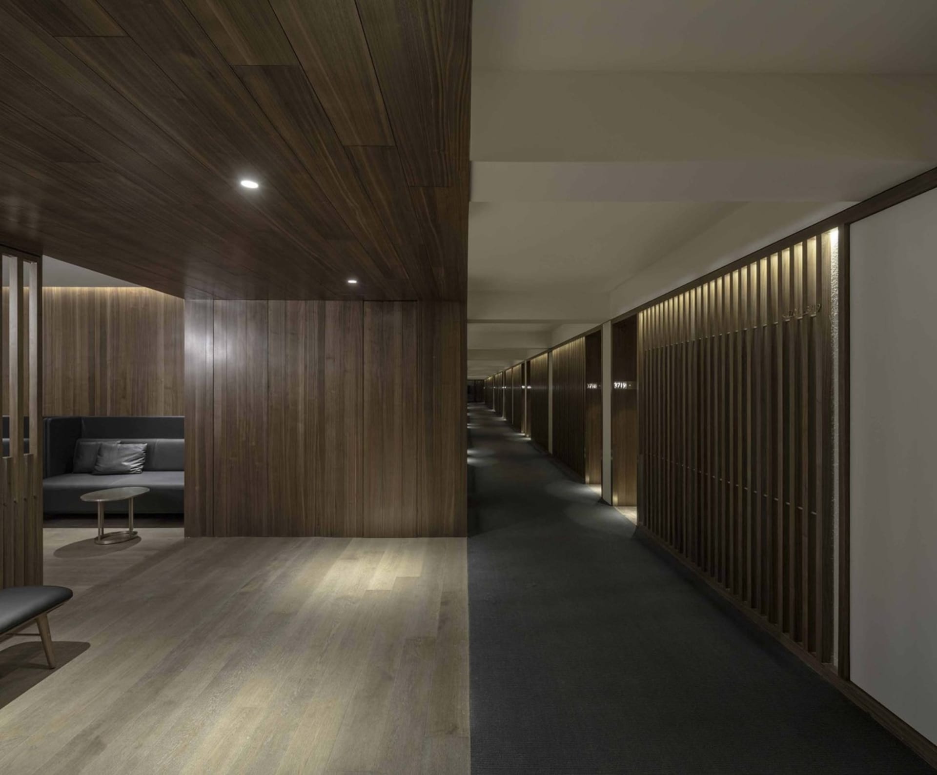 A modern corridor with wooden walls and textured flooring.