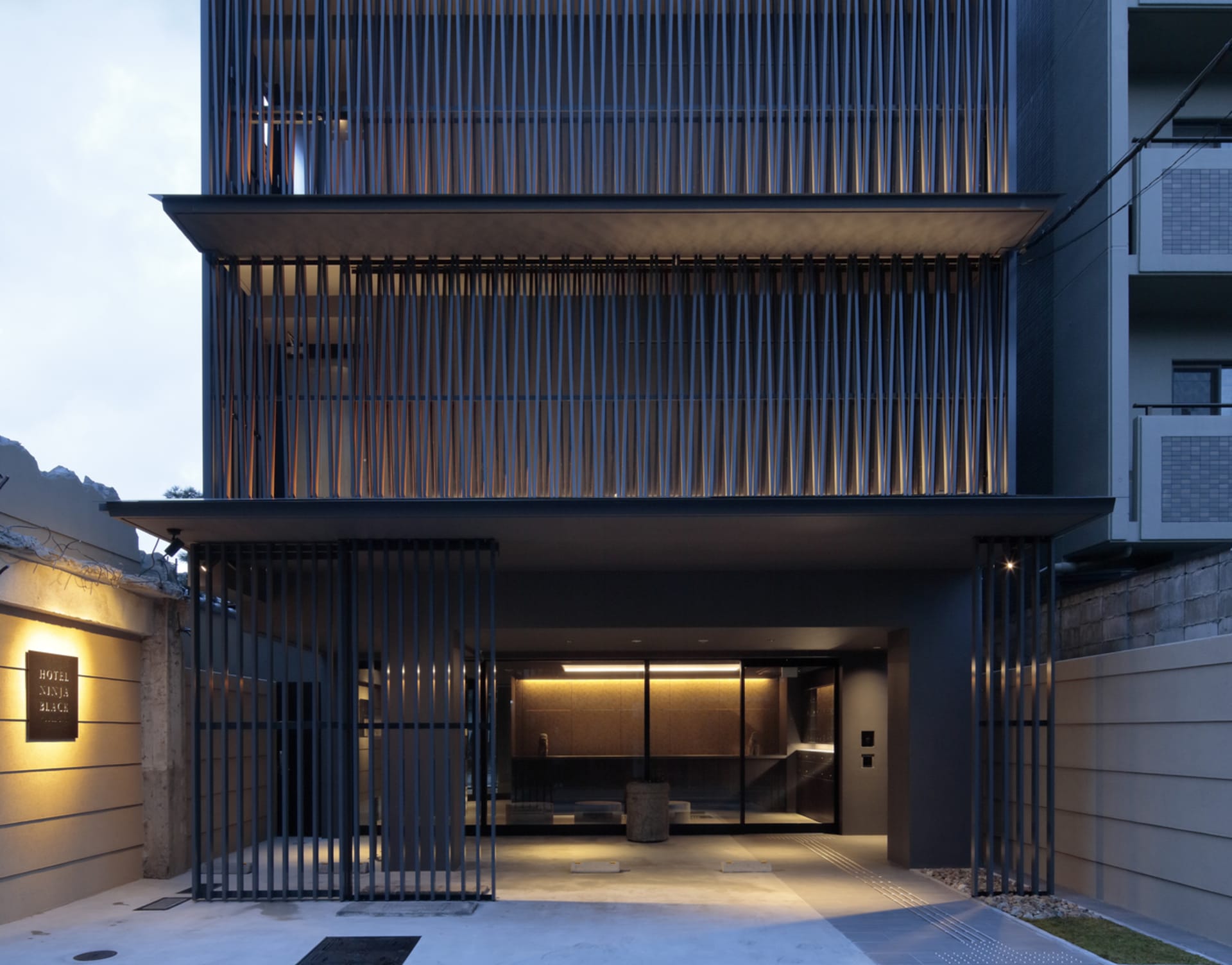Modern hotel entrance featuring metal, glass, and stone materials