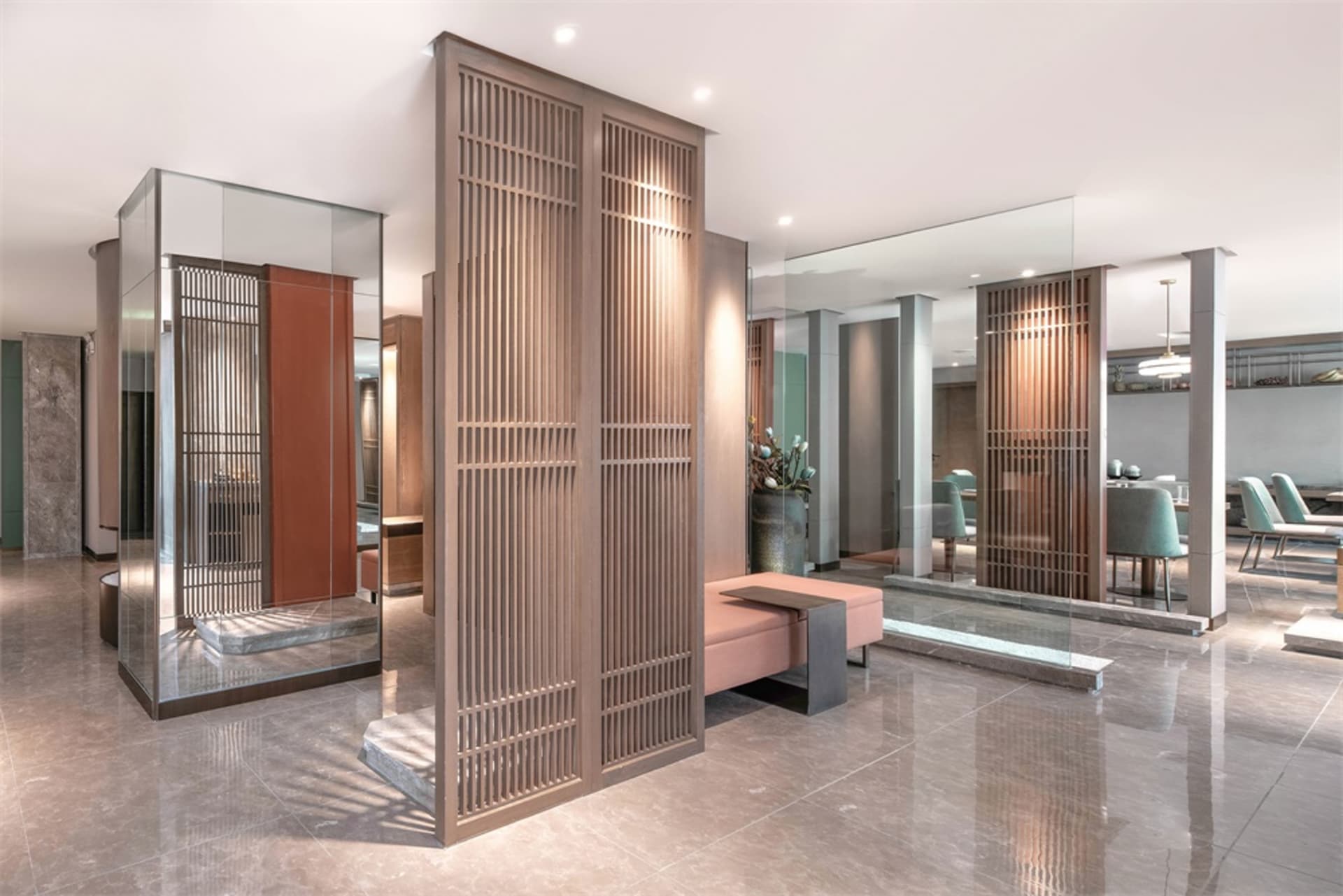 Modern lobby featuring glass panels and ambient lighting.