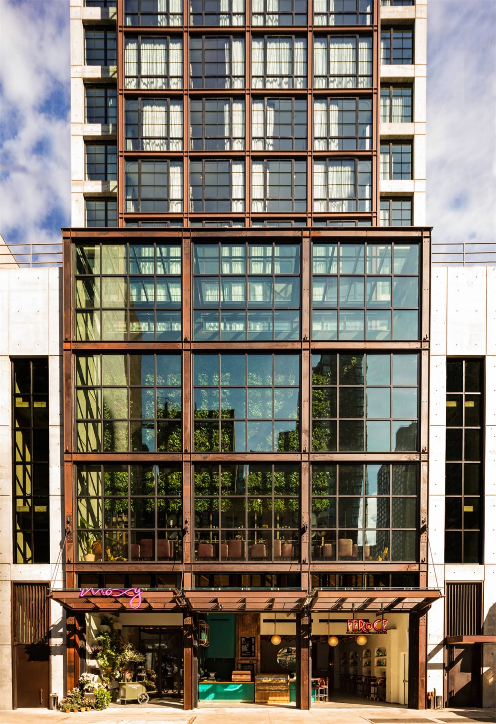 Modern office building with large glass windows and steel framing.