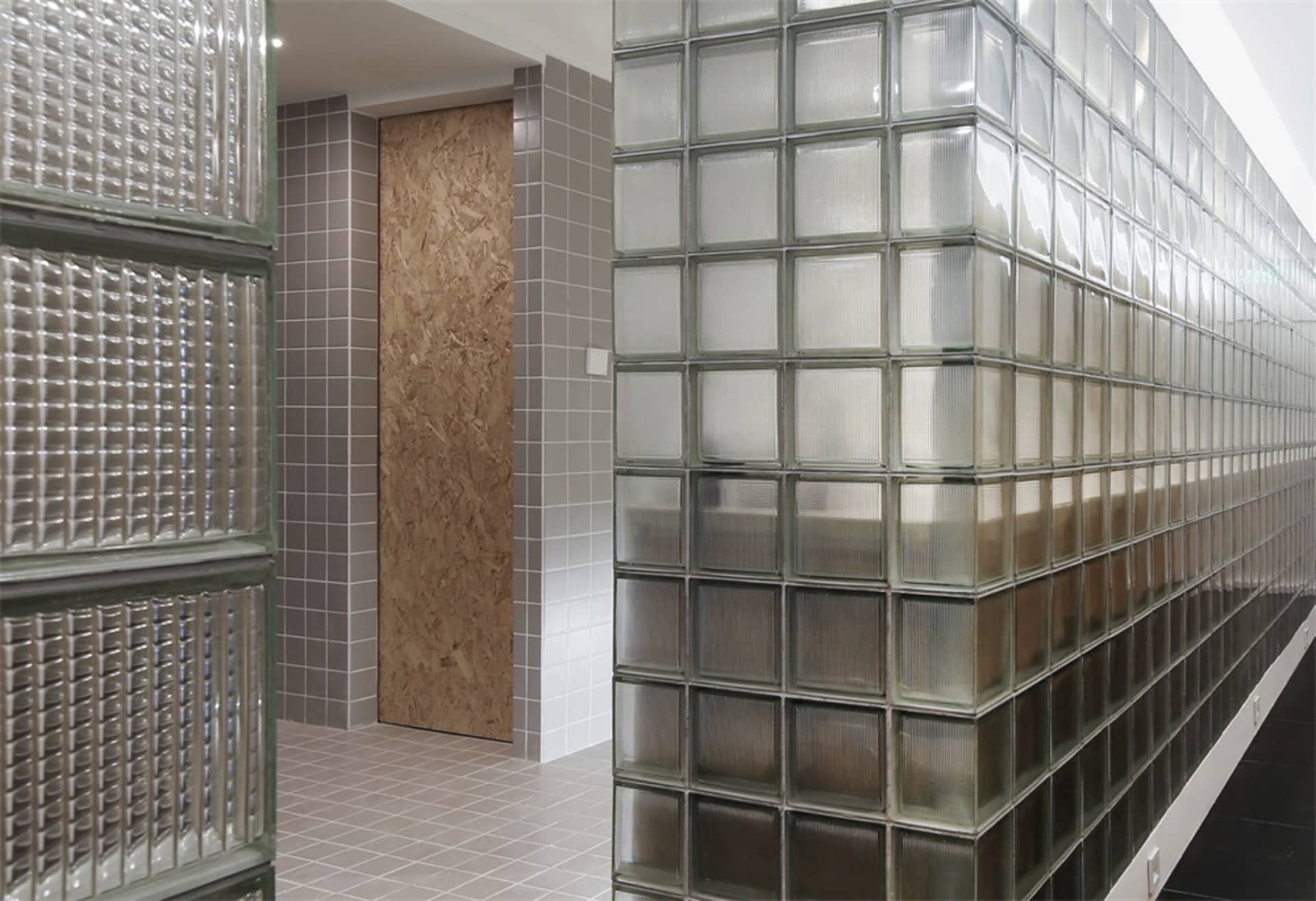 A modern stairwell with walls built from frosted glass bricks