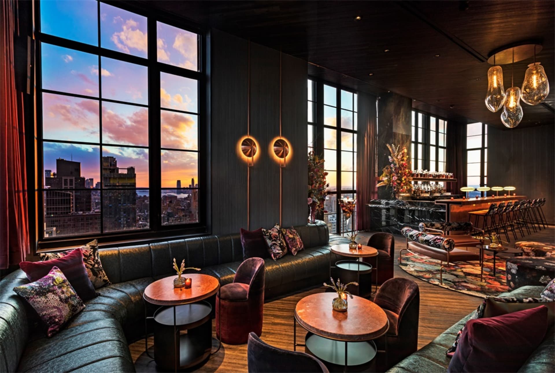 A modern wine bar with sleek leather seating and metal accents, featuring a warm and inviting atmosphere with a city view at
