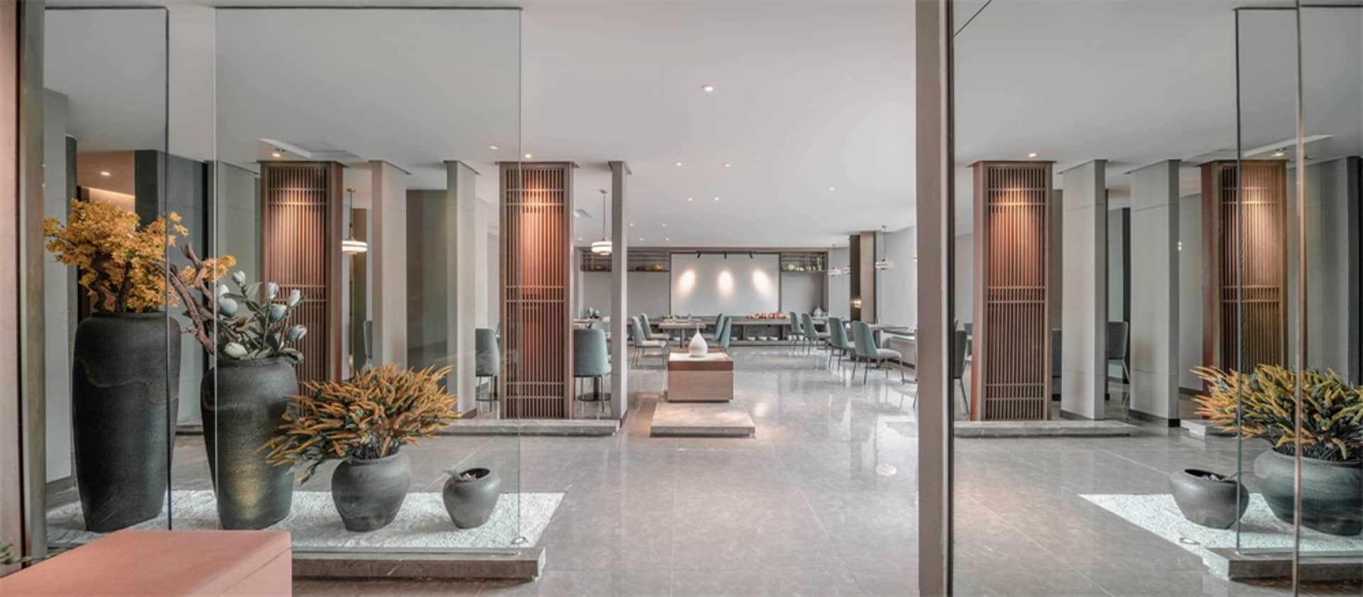 Modern lobby design featuring concrete and glass elements.