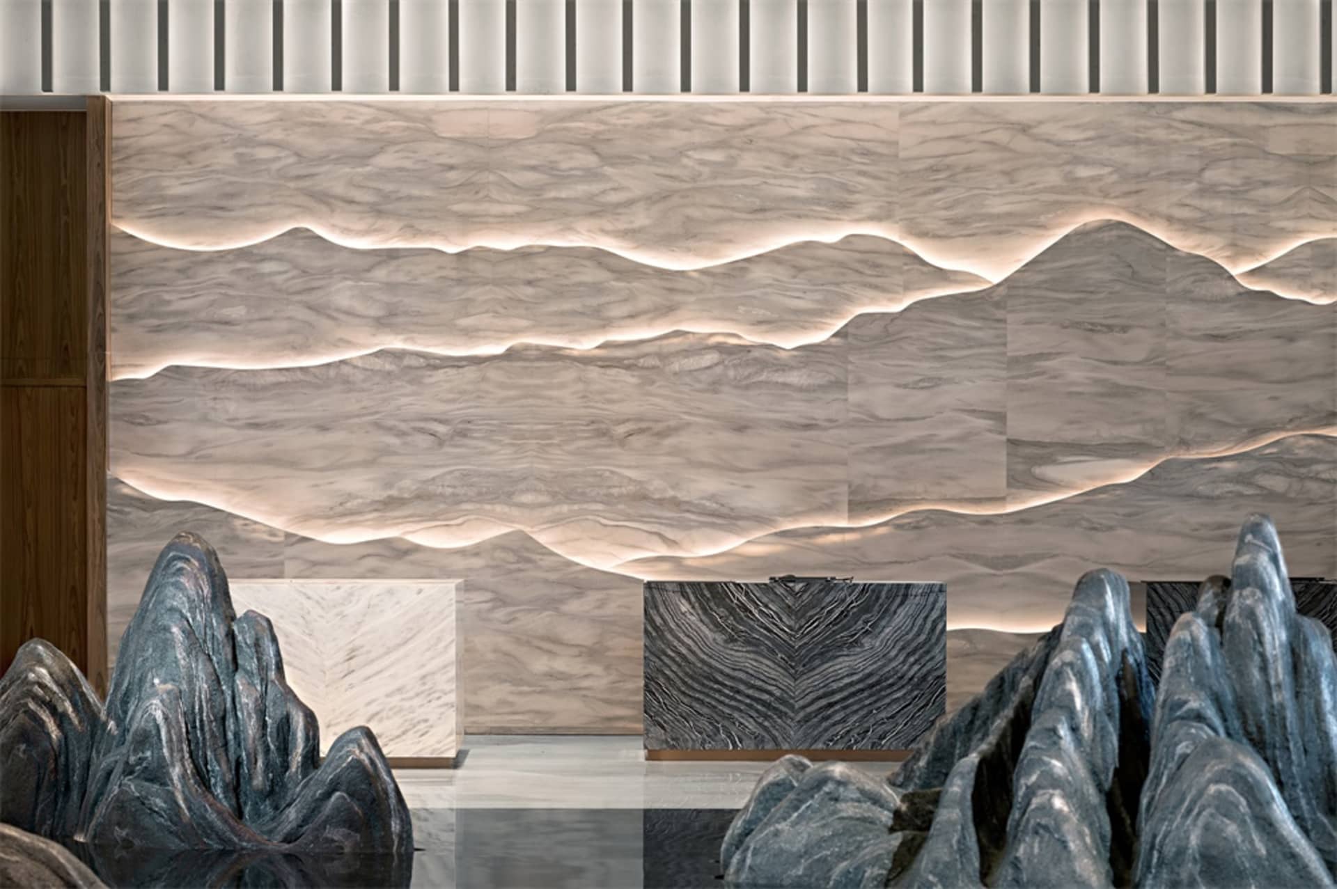 A modern lobby featuring marble, concrete, and metal materials.