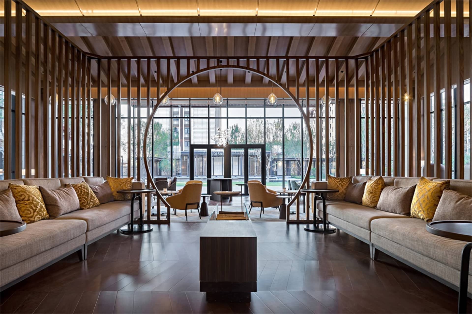 Modern, open-concept lobby featuring wooden accents and glass walls.