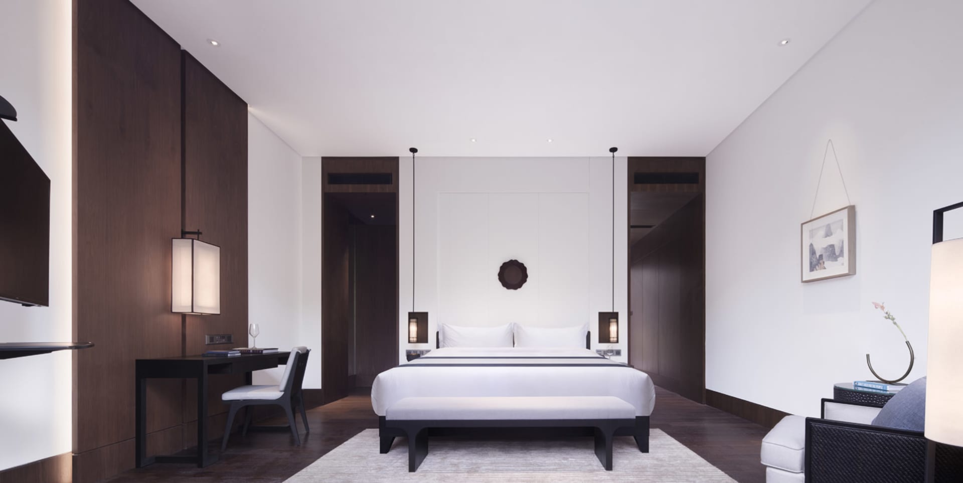 A minimalist bedroom featuring wood, leather, and metal materials.
