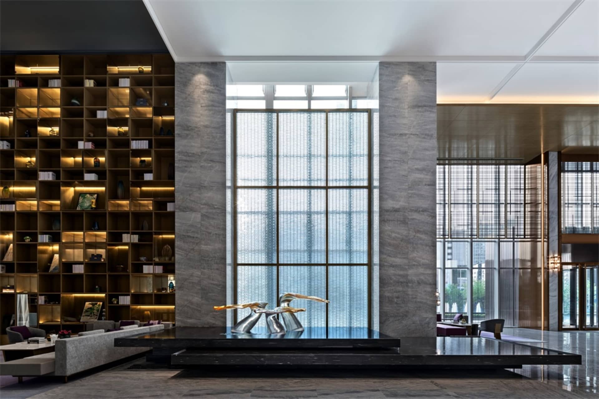 A modern, spacious lobby featuring a sleek marble and glass design