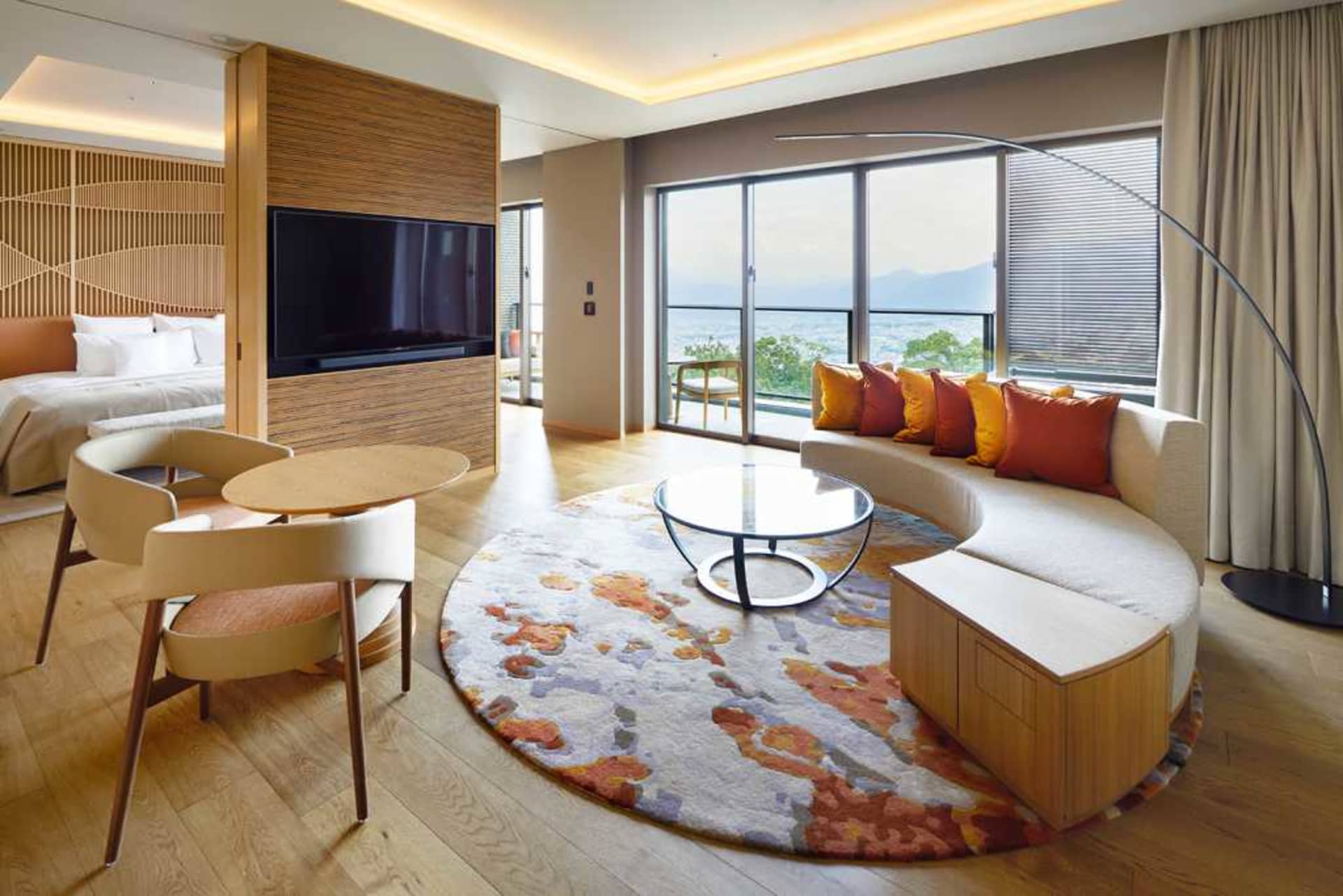 Living room with modern tiles and furniture, featuring a round rug and a sofa.