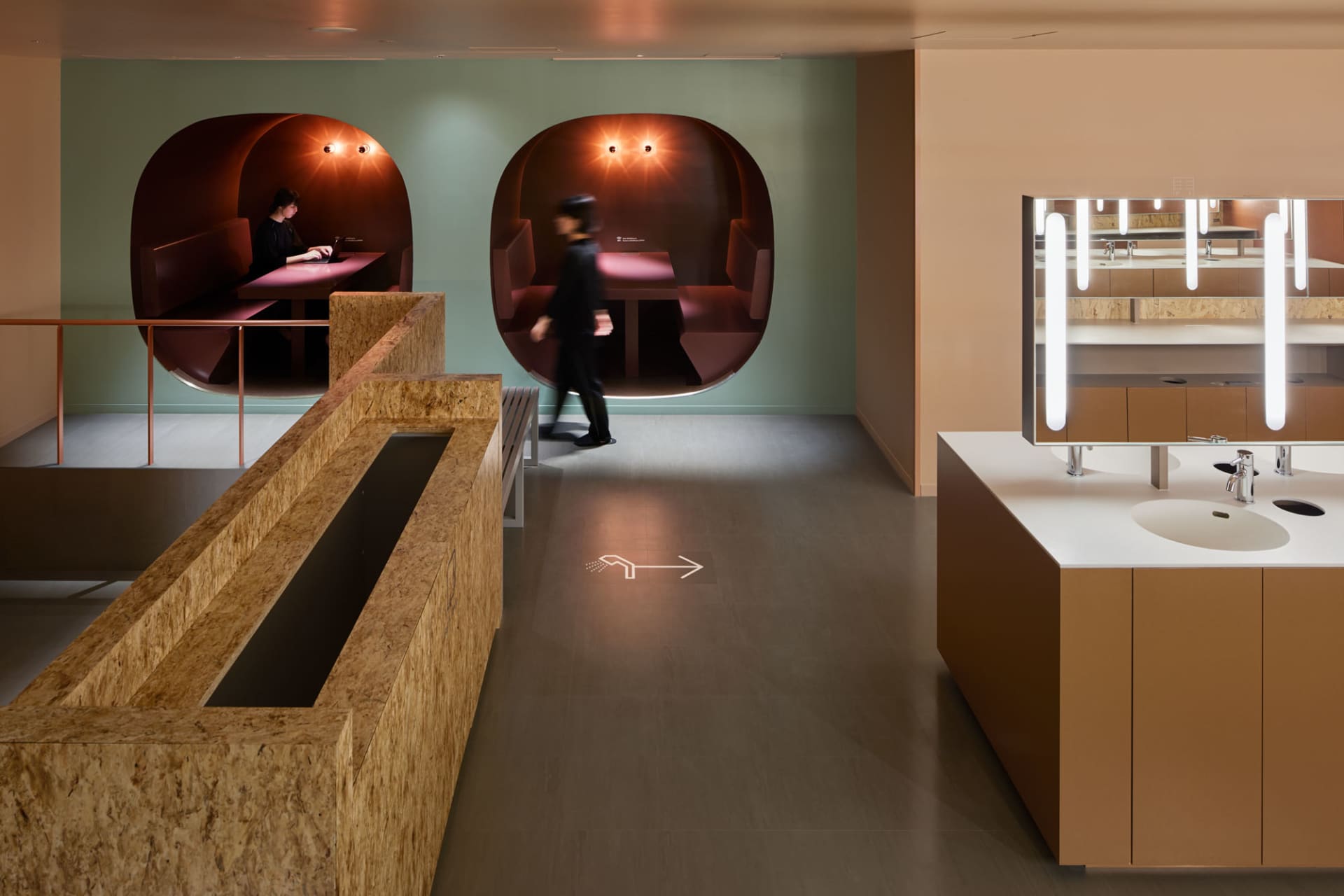 A modern industrial office space with concrete, wood, and glass elements.