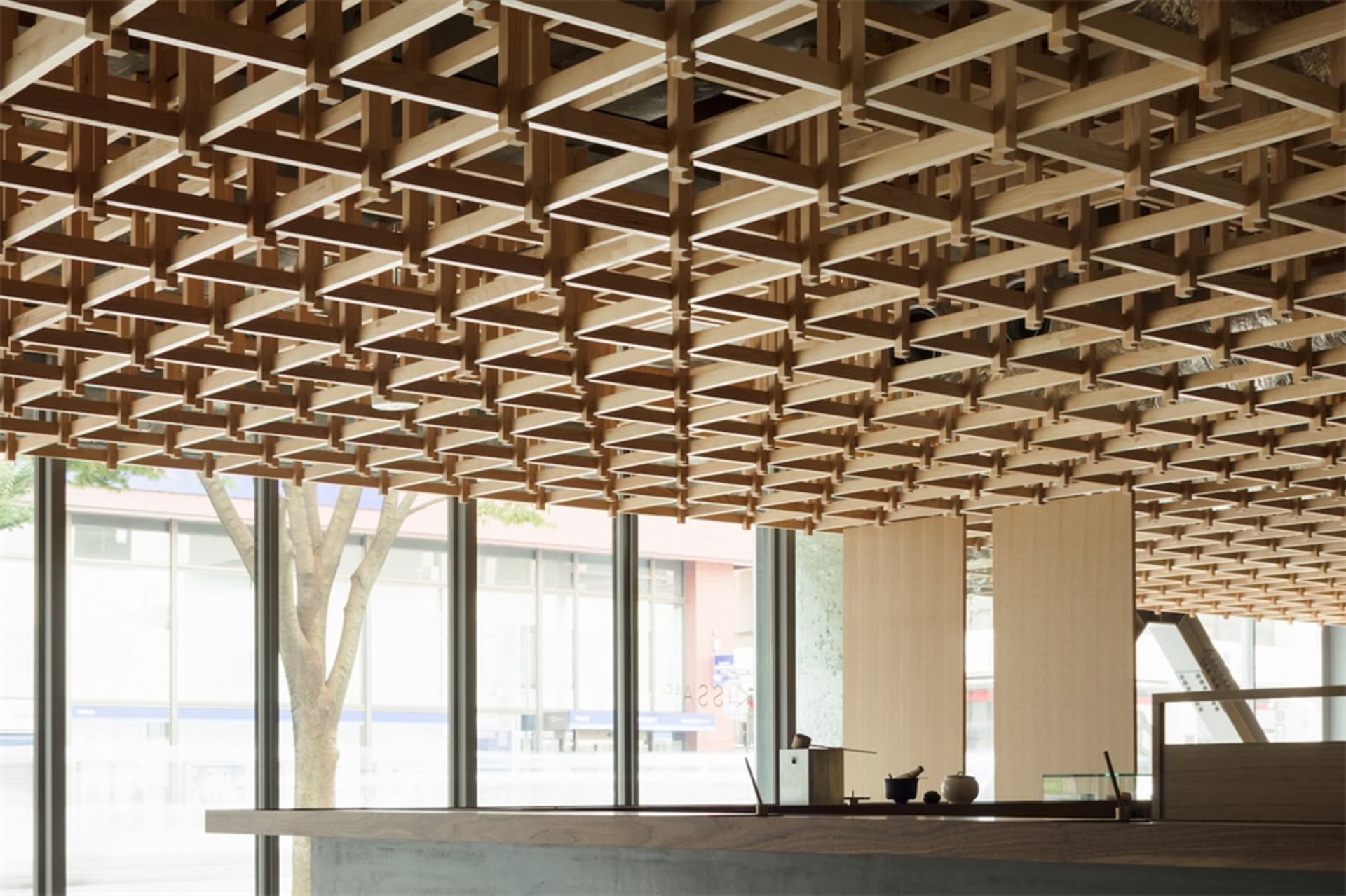 Modern office space with a wooden grid ceiling design.