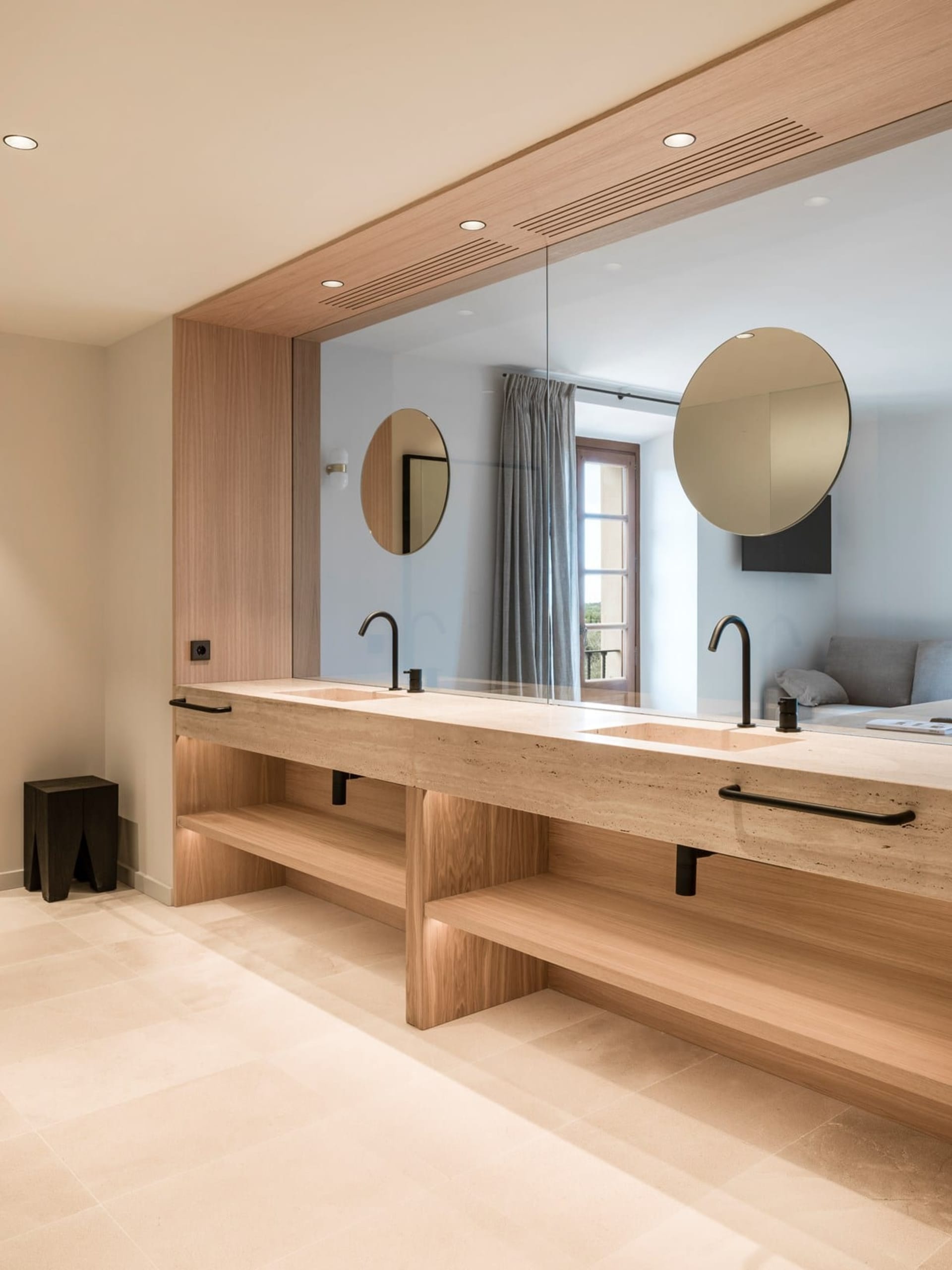 Modern bathroom with concrete countertop and wooden shelves.