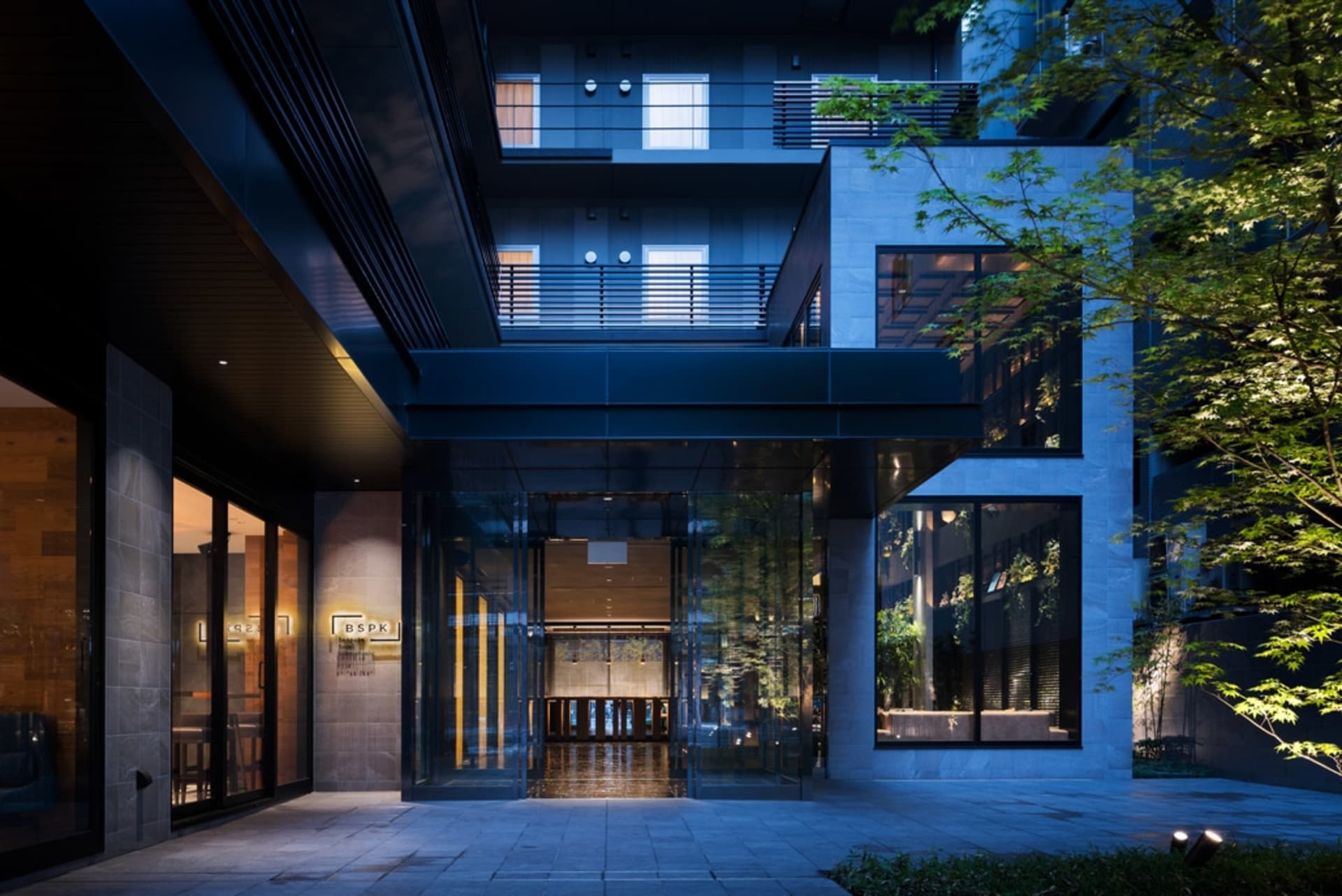 Modern architecture featuring glass walls in an interior space.