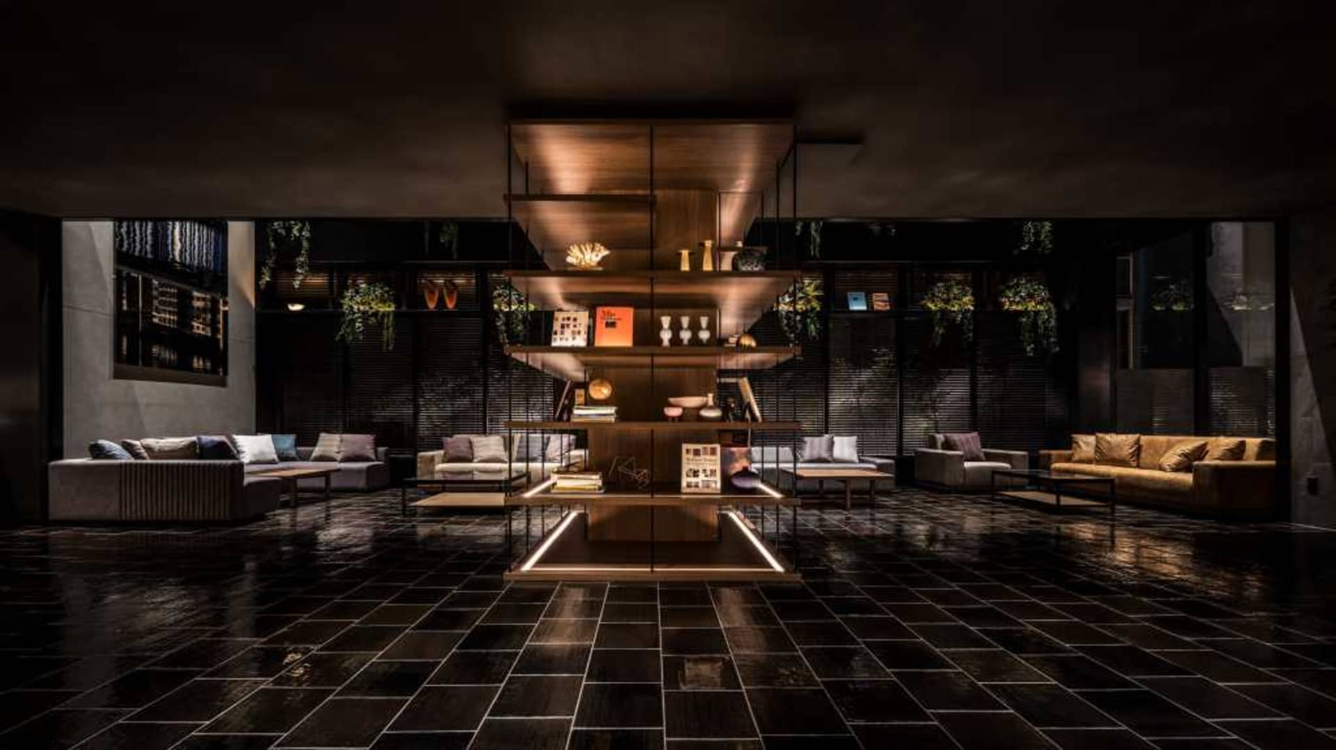 A minimalist hotel lobby with wooden shelves, glass and concrete elements.
