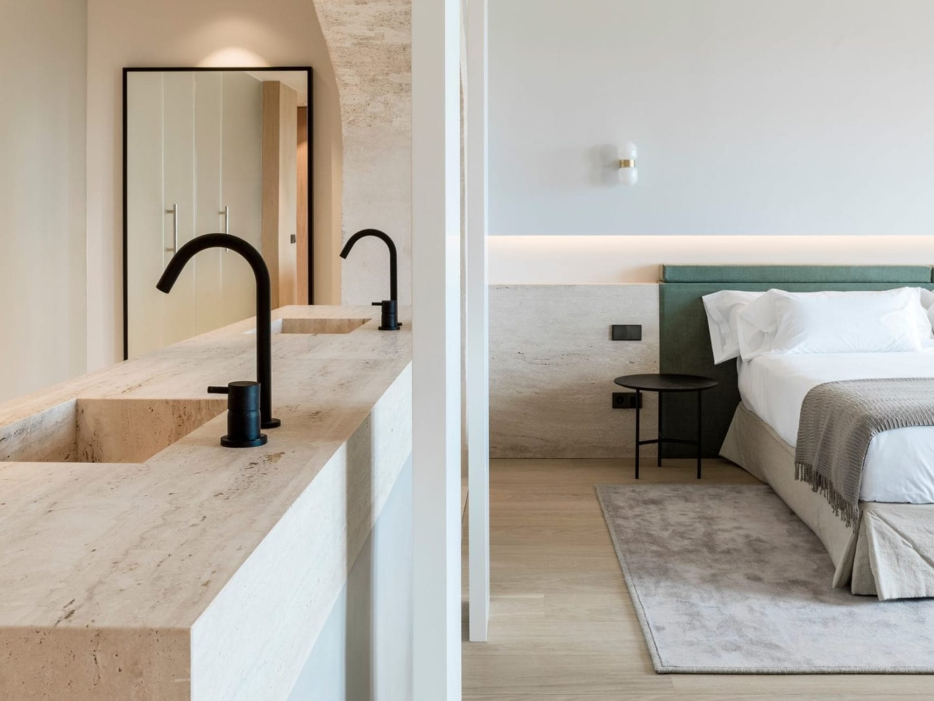 A minimalist modern bedroom with marble and concrete finishes.