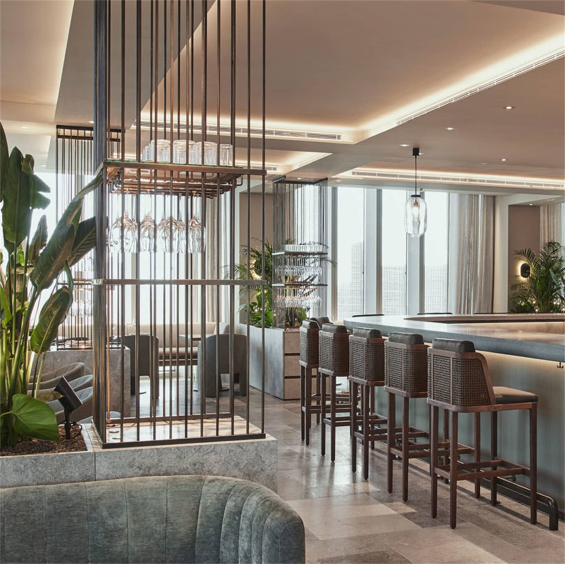 A contemporary industrial-style bar with metal fixtures and a sleek, modern design.