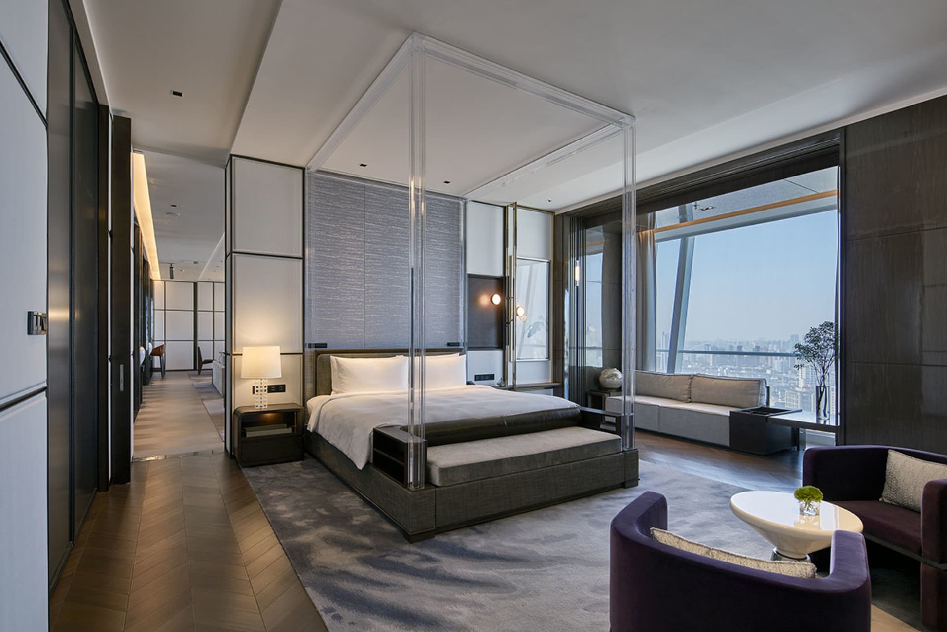 A modern hotel suite featuring glass and steel materials, designed to provide a luxurious and contemporary experience.