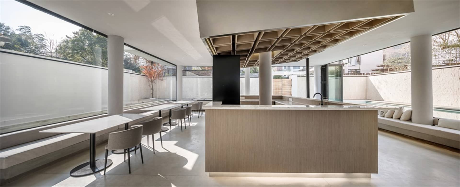 Modern cafe bar interior with concrete, marble, and wooden finishes