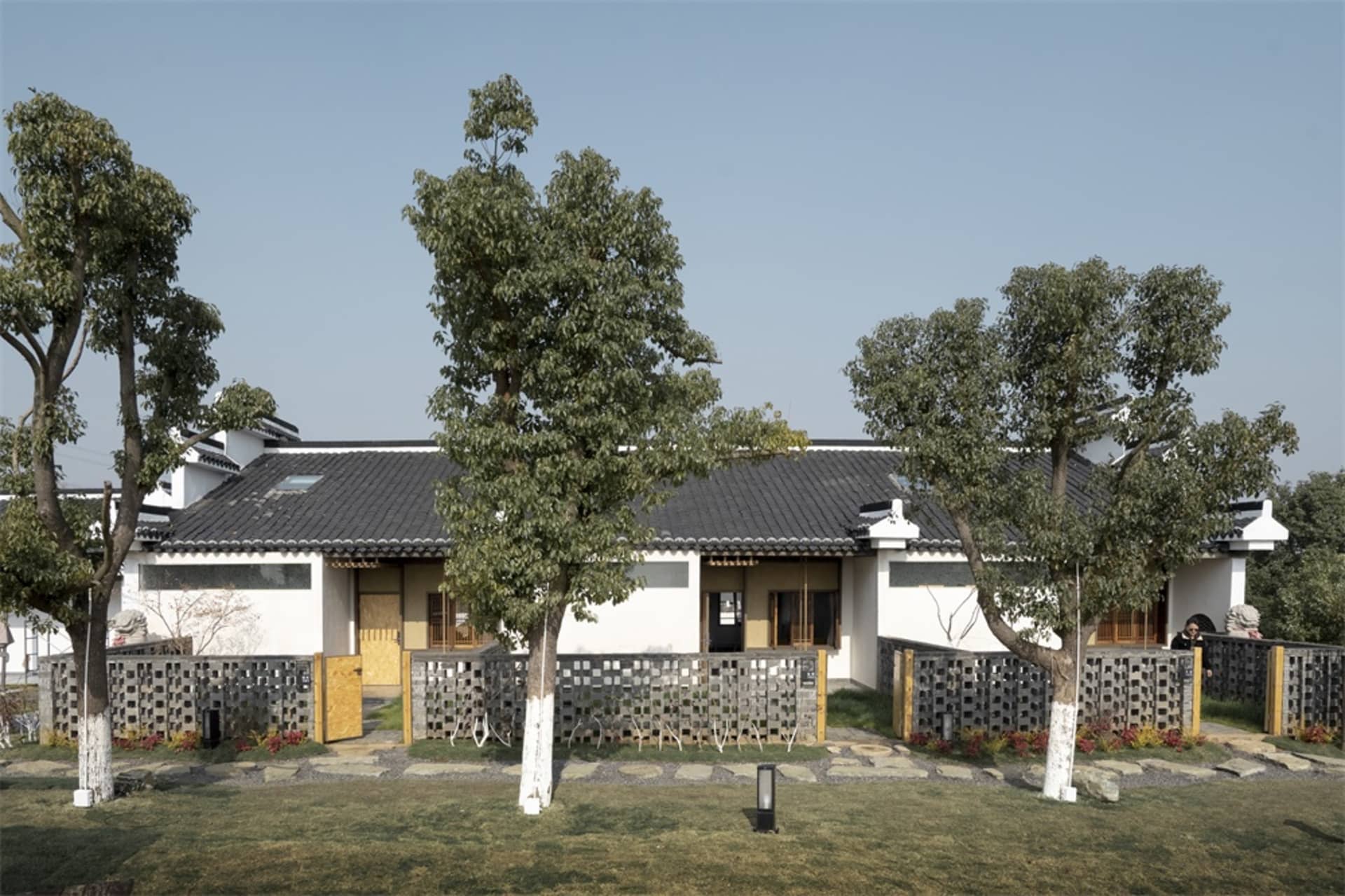 Traditional white residential architecture with wooden and stone elements.