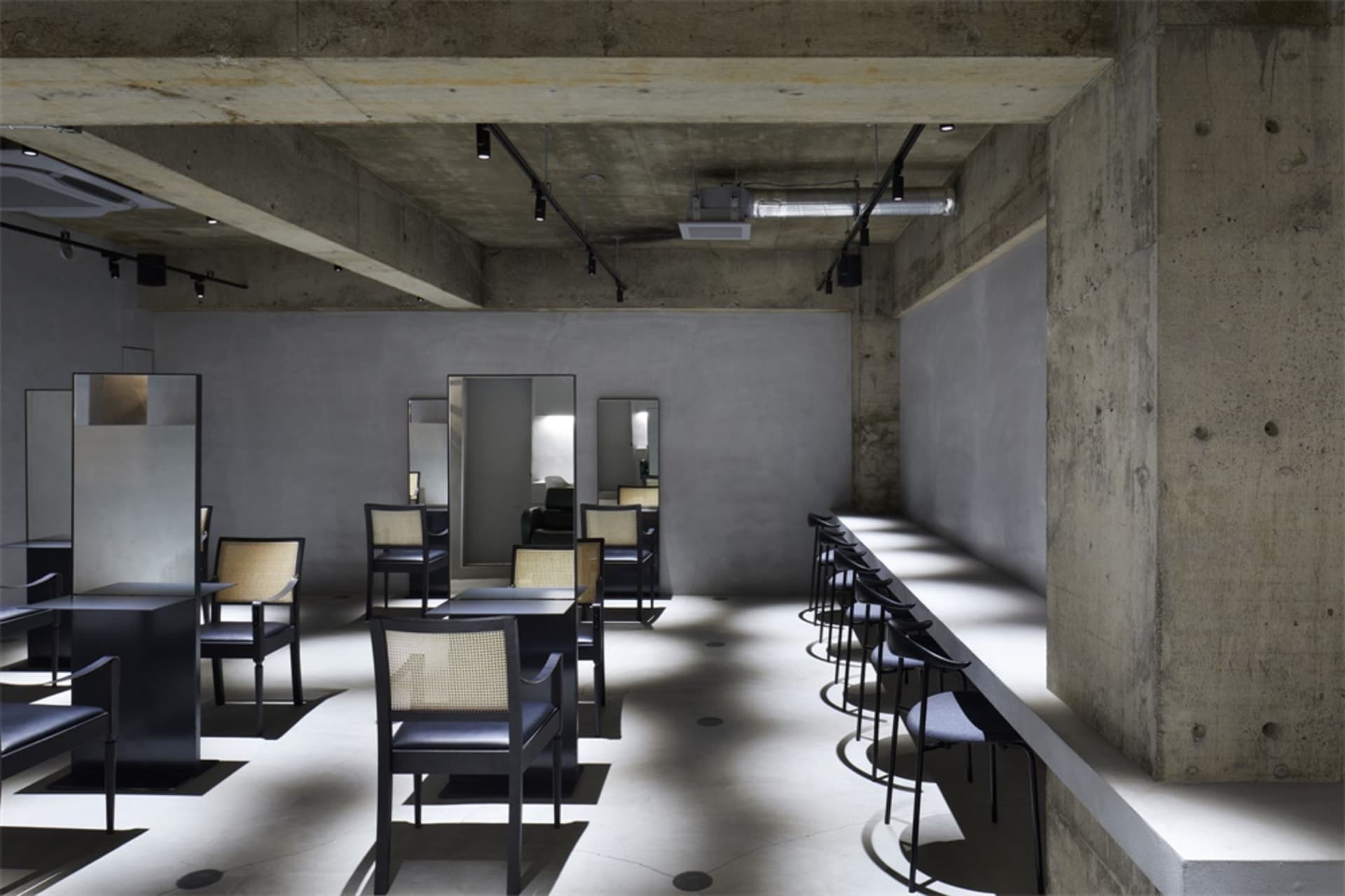 Concrete restaurant with industrial seating