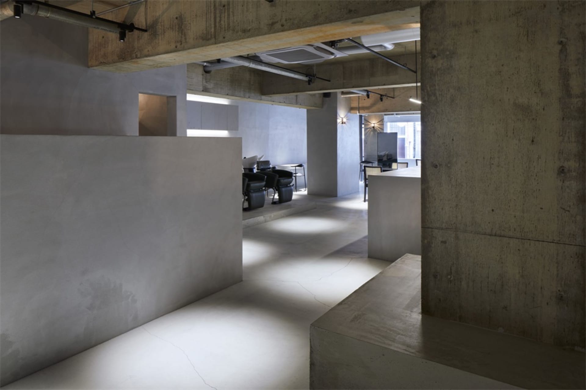 Industrial-style office space with concrete walls and floors.