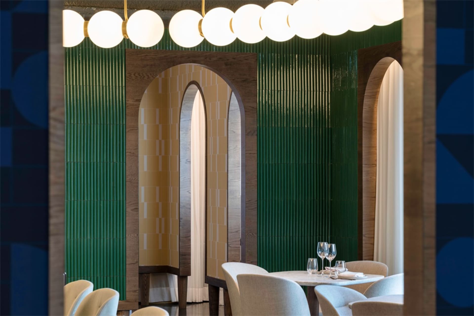 Modern restaurant interior featuring wood, curved glass, and green tiles.