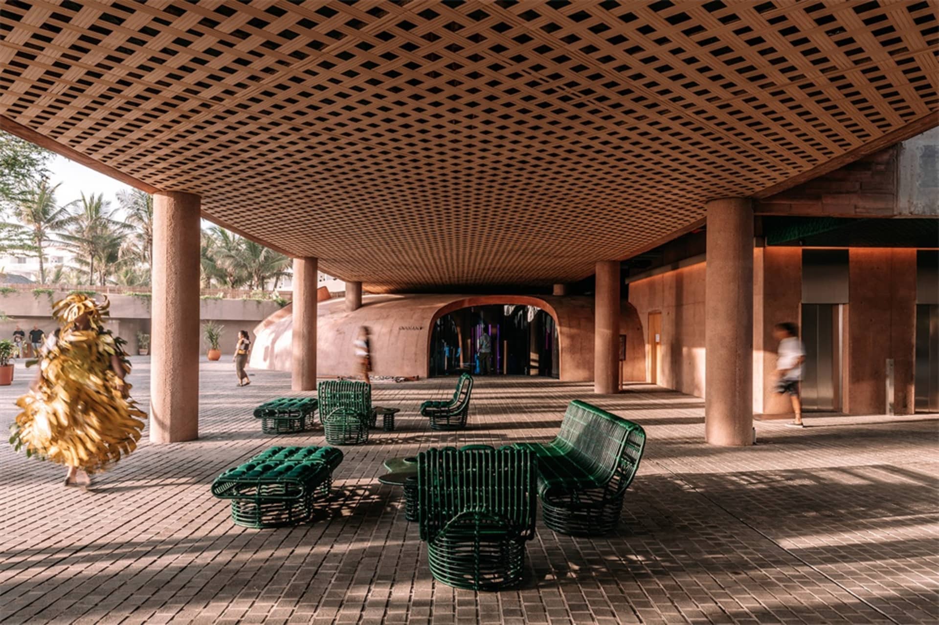 Industrial-style interior space featuring a wooden seat under a lattice ceiling.