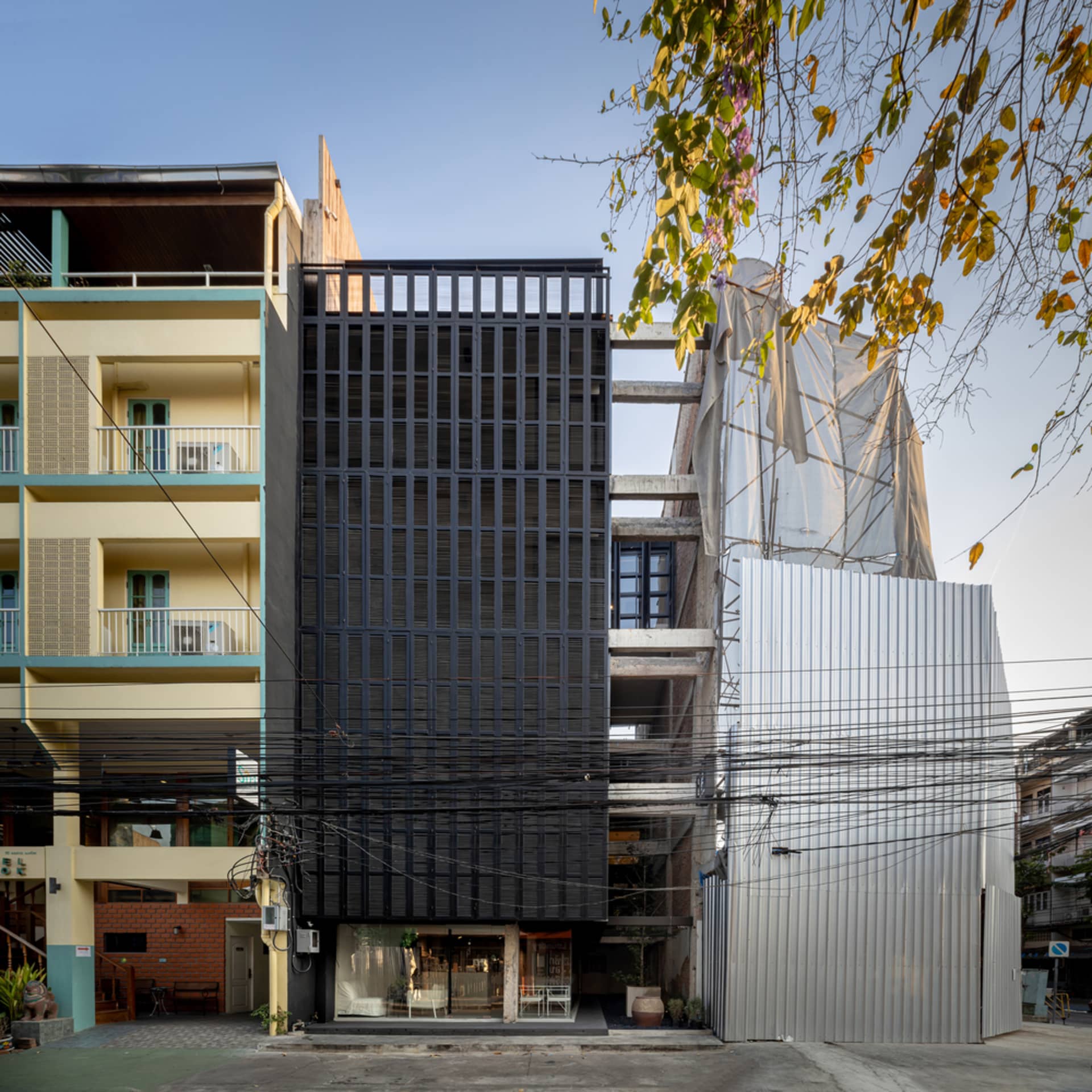 A modern urban building with metallic exterior and grid-like facade.