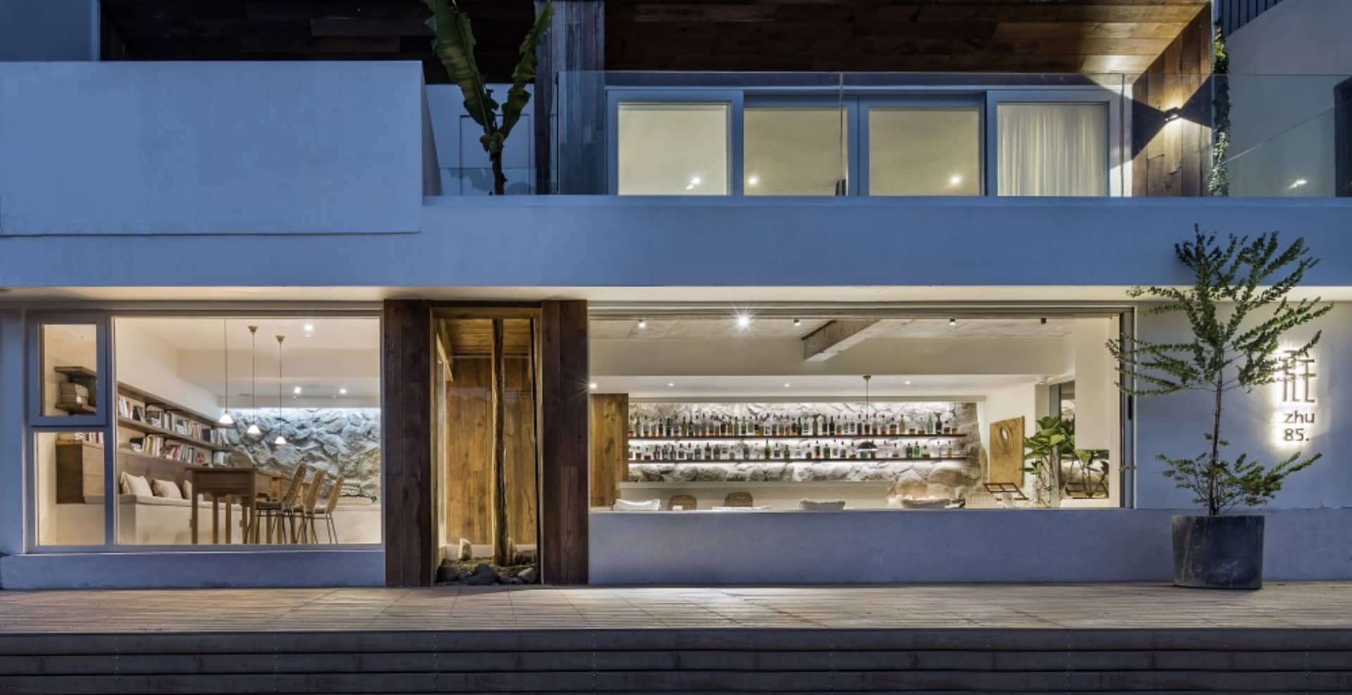 Modern retail storefront with a wooden entrance, concrete storefront, and glass window
