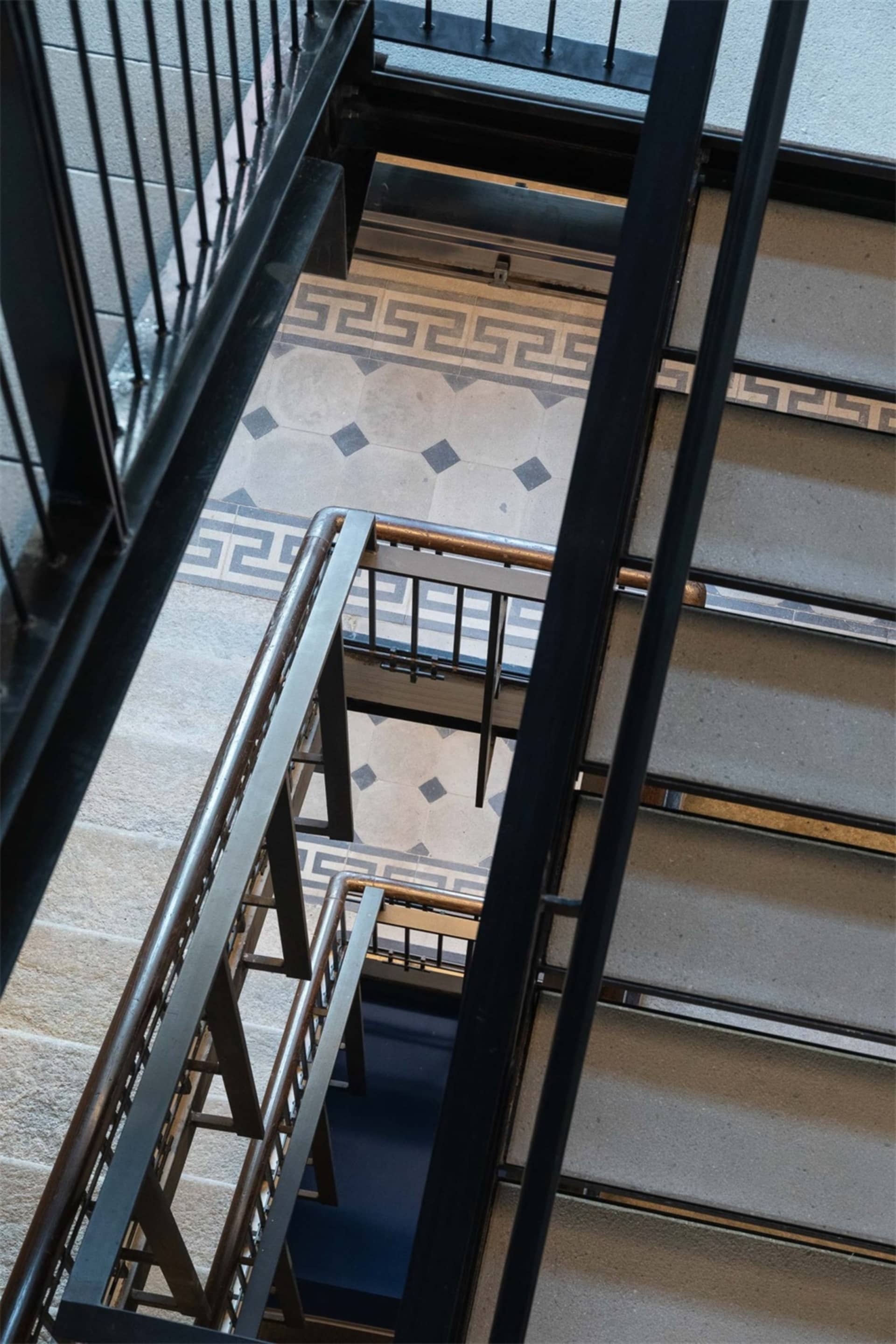 Modern staircase featuring metal railings and concrete steps