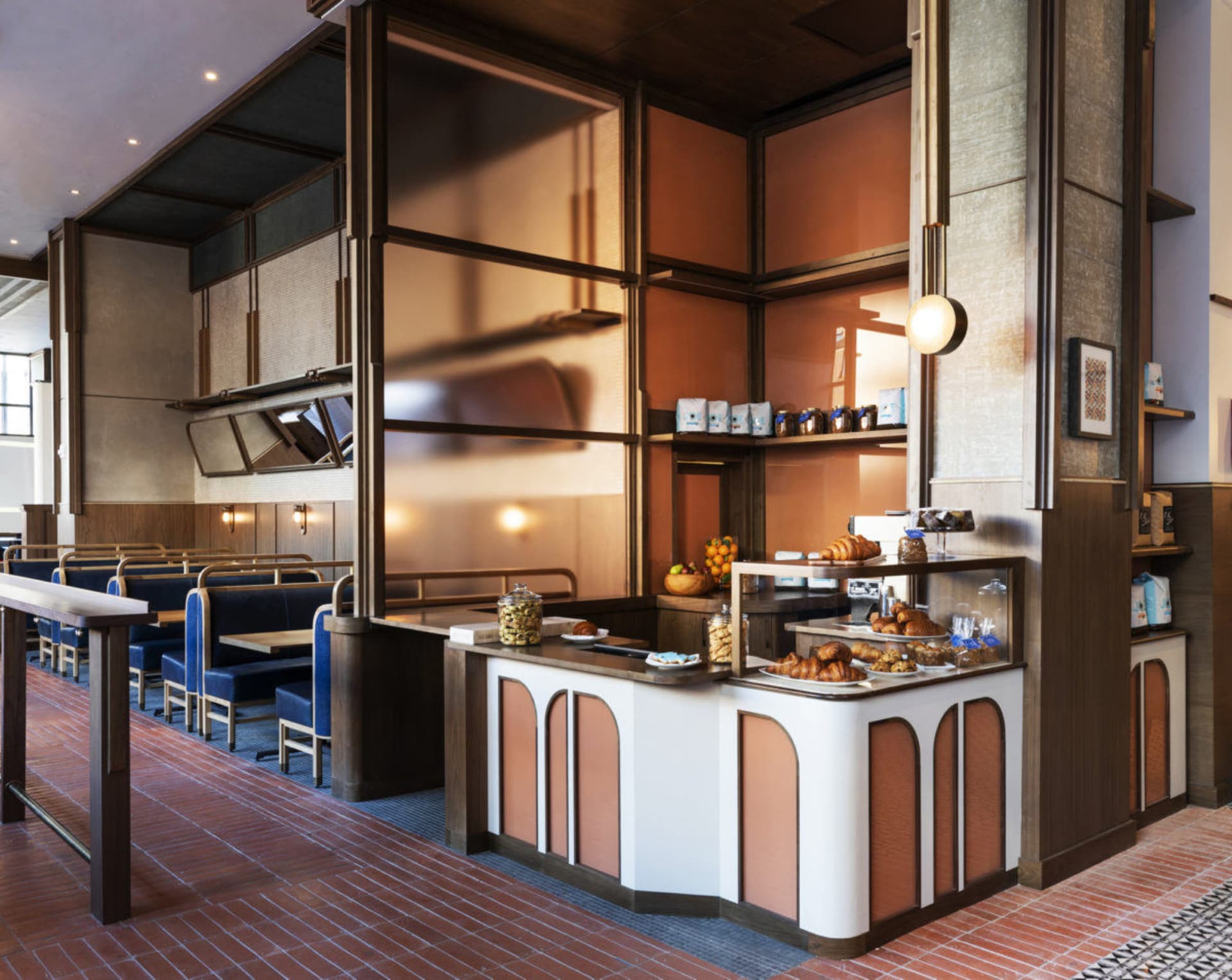 Modern restaurant cafe interior with seating, counter, and display case.