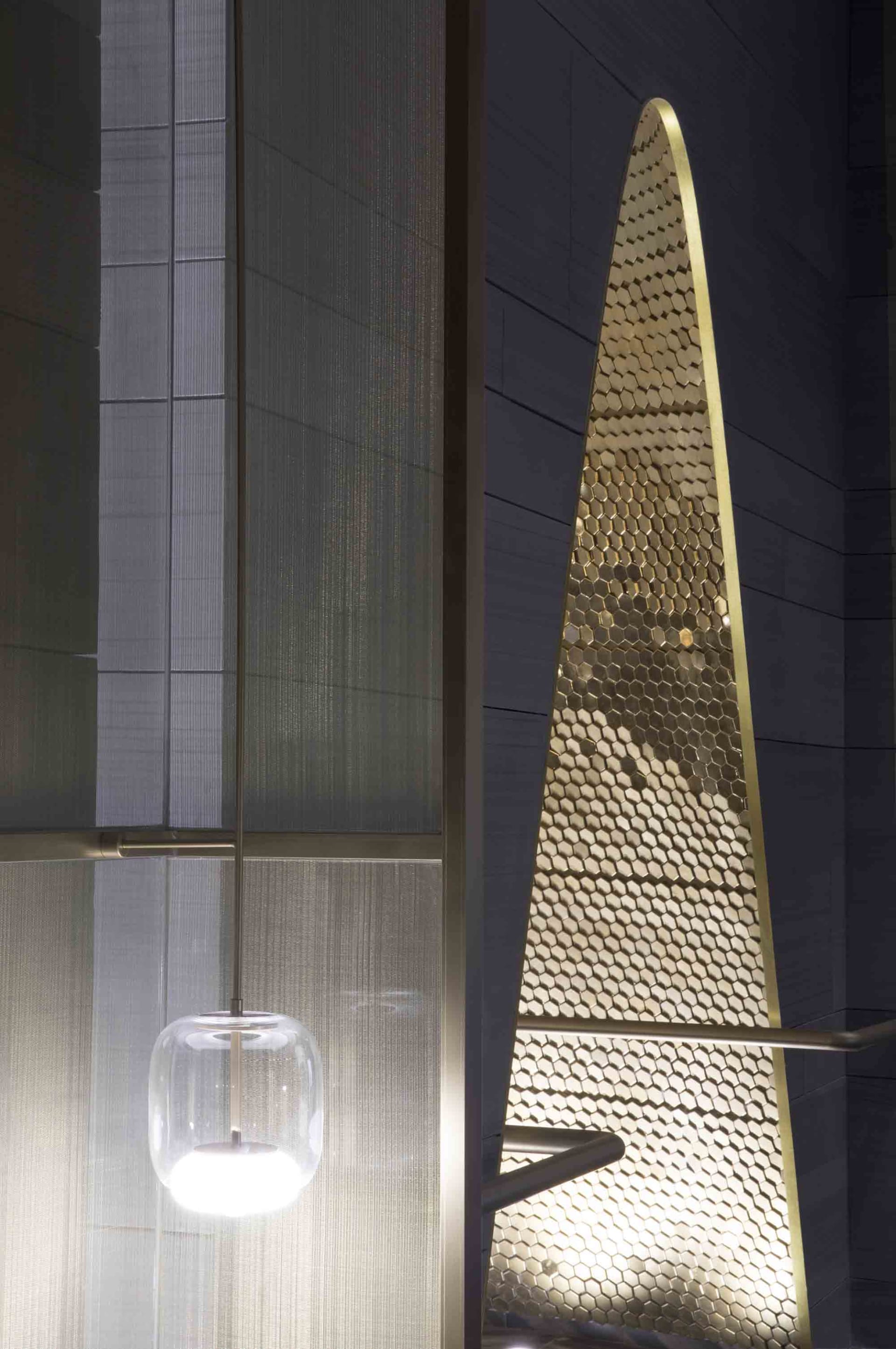A modern staircase design featuring metallic mesh material.
