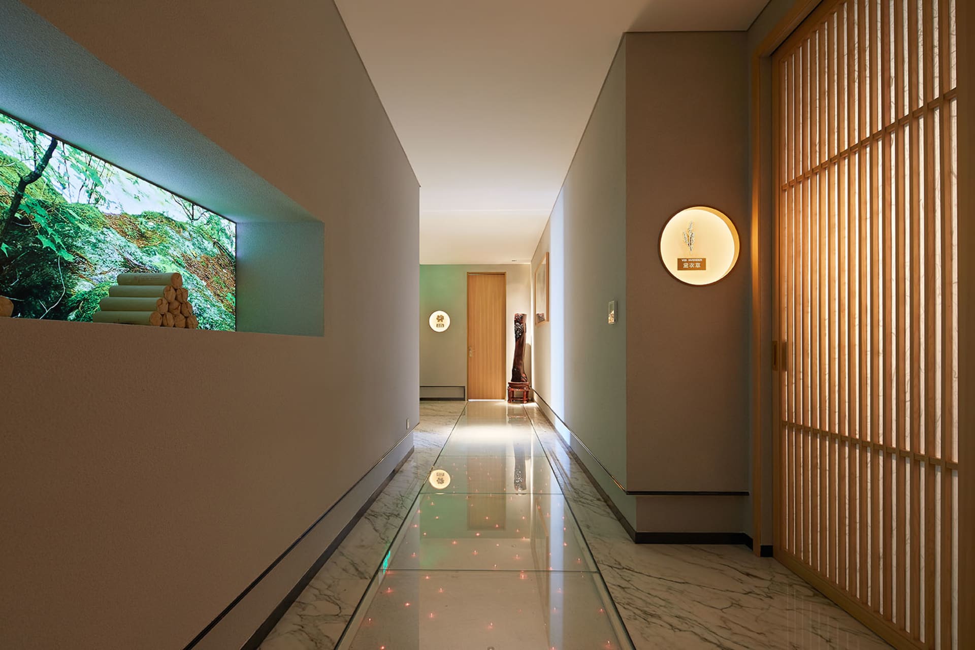 Modern interior design featuring a corridor with marble flooring and wooden accents.