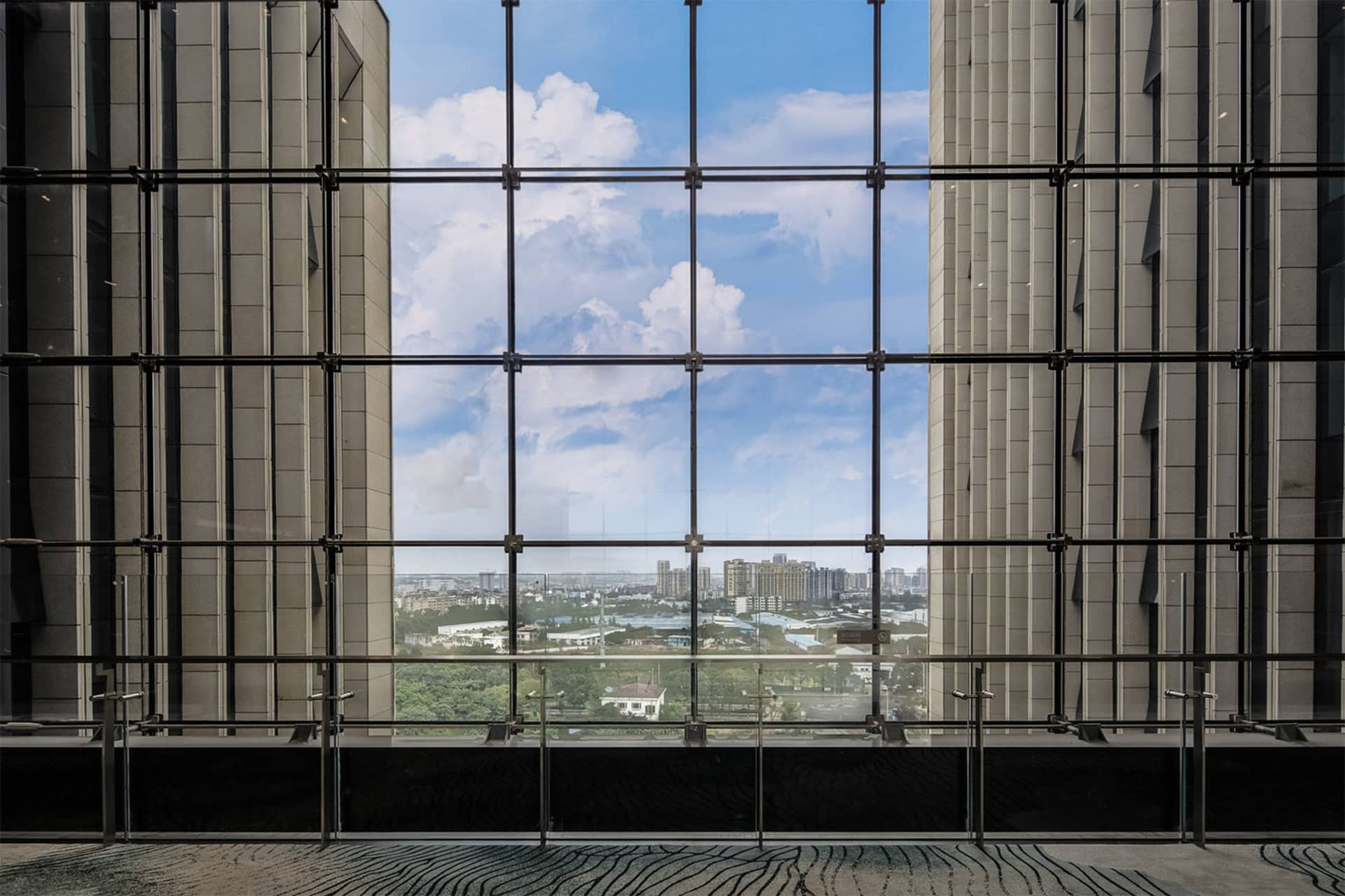 High-rise building with panoramic cityscape view through glass windows.