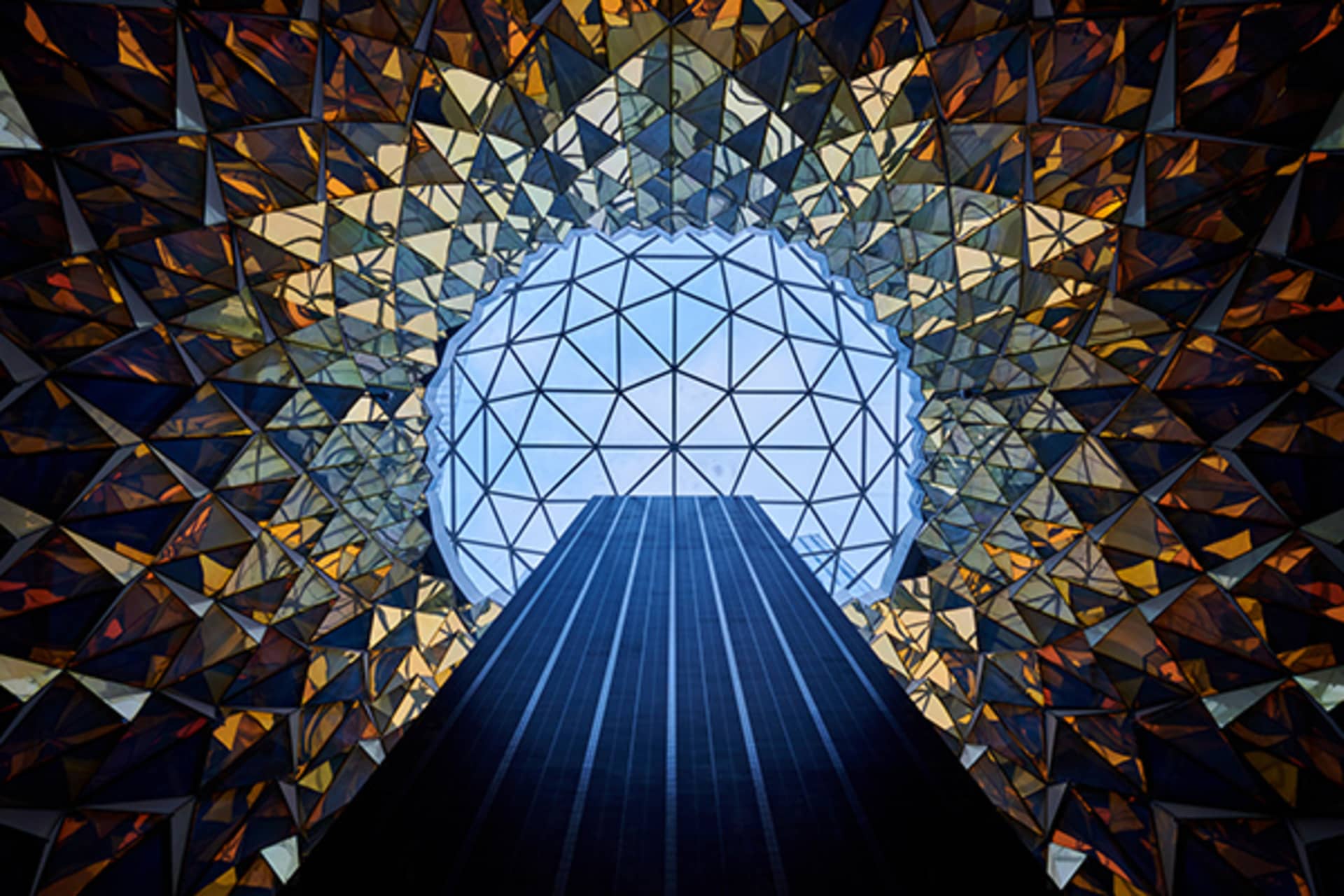 A modern interior with glass walls and a geometric glass dome