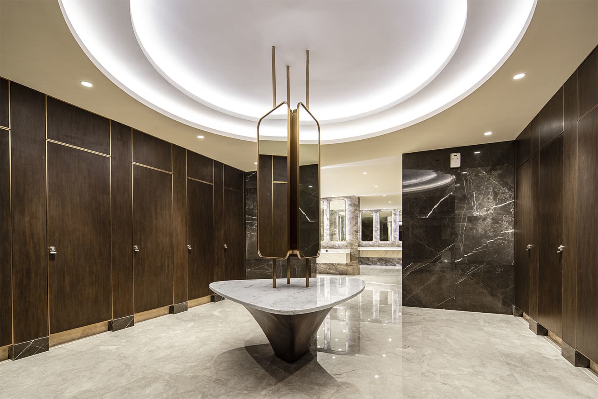 An elegant bathroom with marble and concrete finishes, featuring multiple sinks and mirrors.
