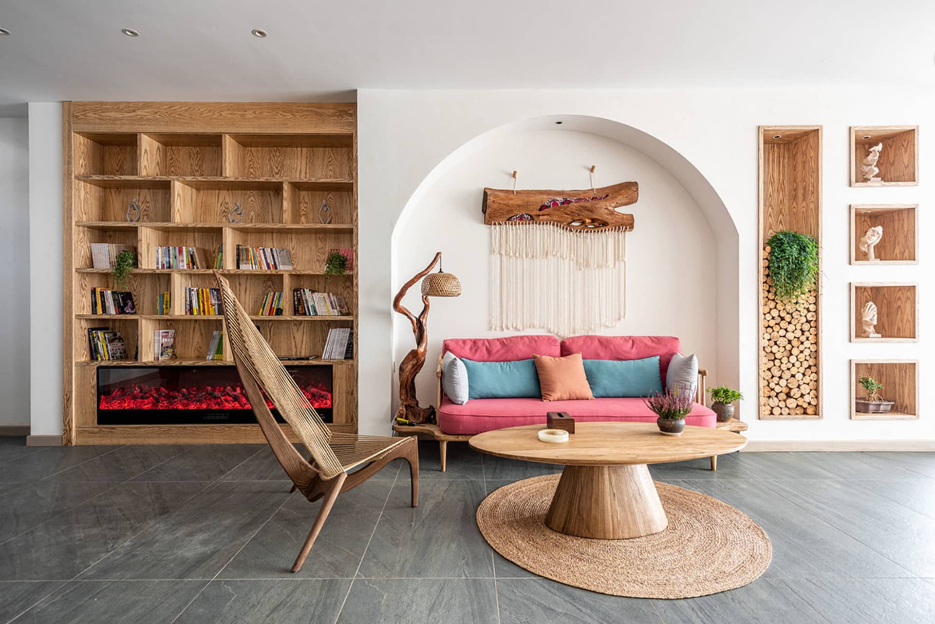 A modern living room with wooden furniture and a large bookshelf.