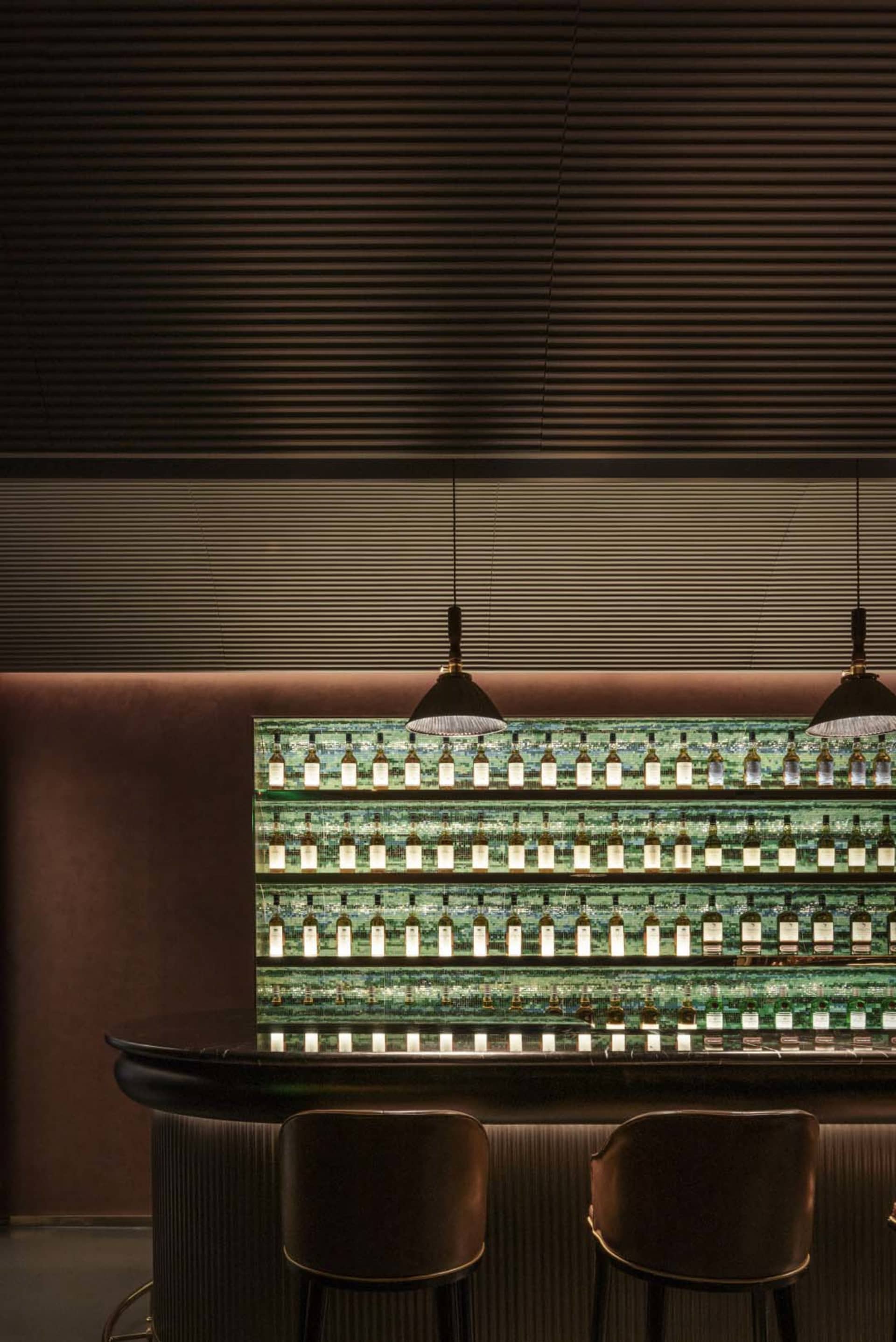 Modern bar counter adorned with green glass tiles