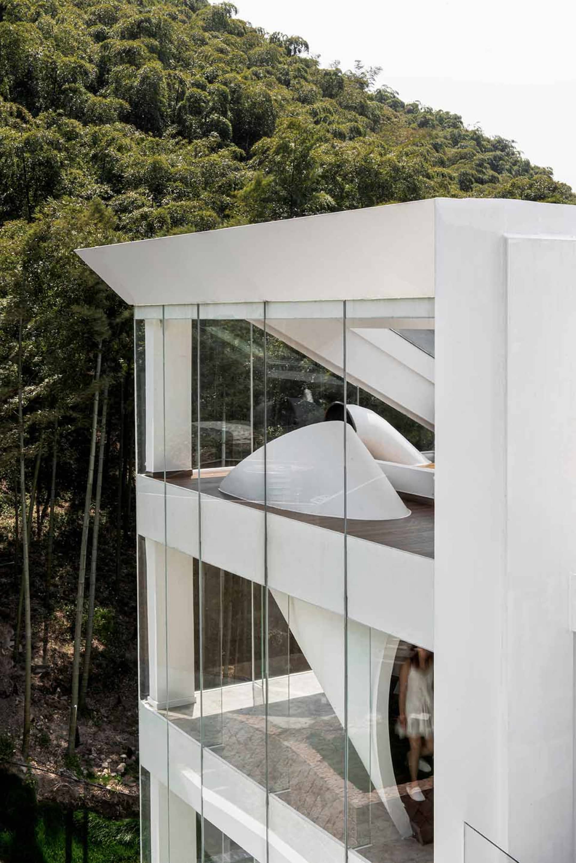 Modern residential building with glass and concrete exterior.