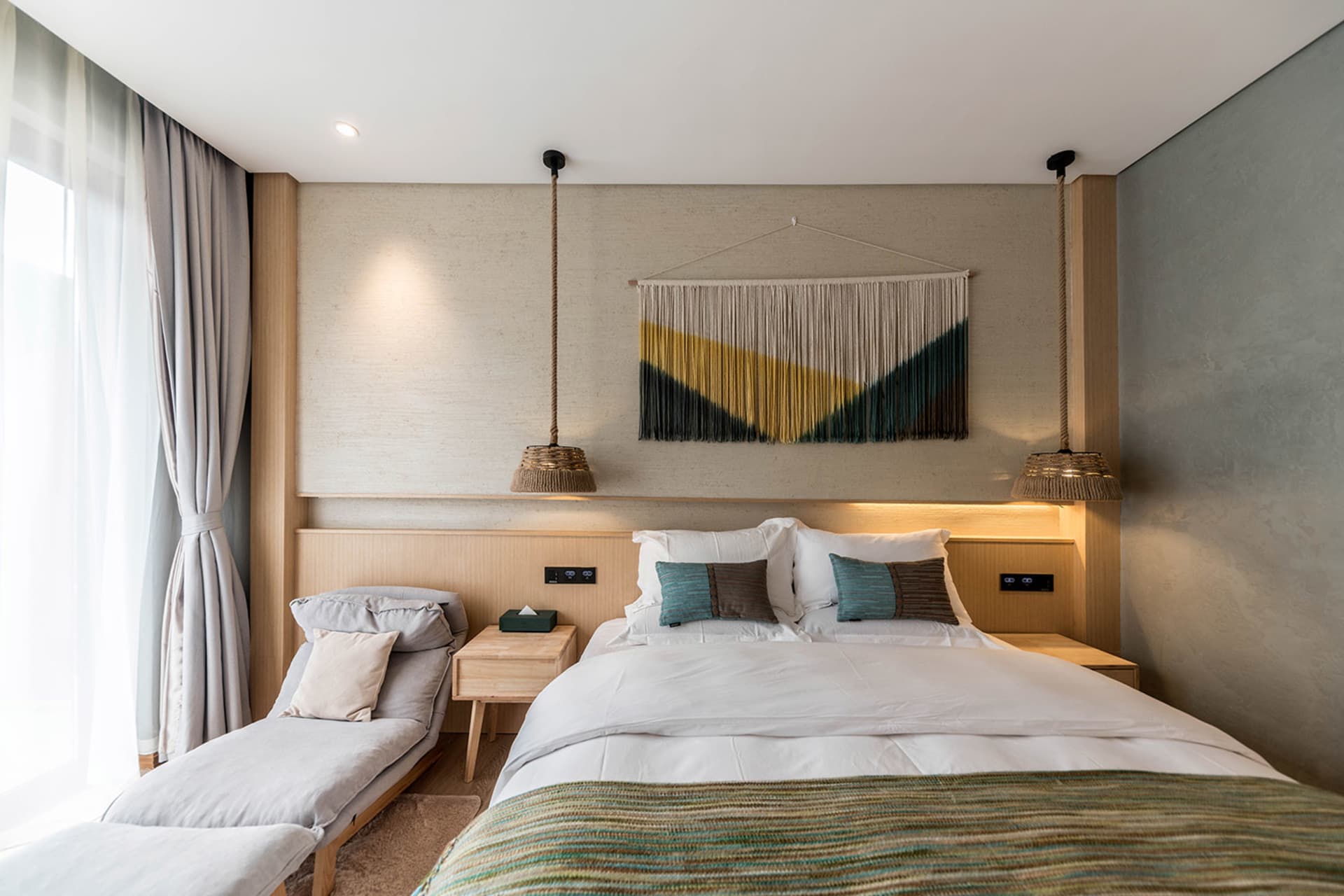 Modern minimalist bedroom featuring wooden furniture and concrete walls.