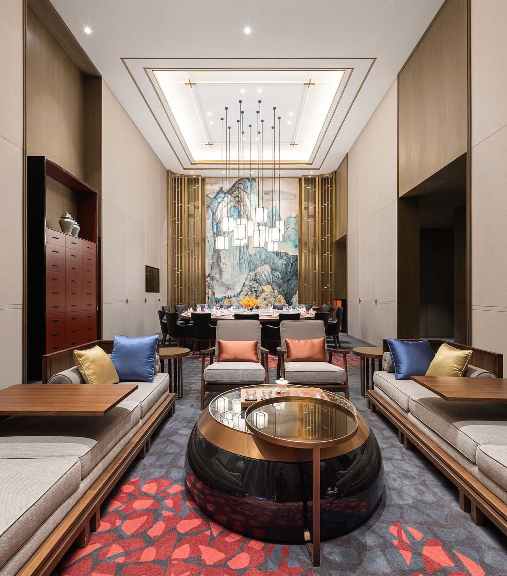 Well-designed hotel lounge featuring modern furniture, wooden accents, and textile upholstery, with a central coffee table.