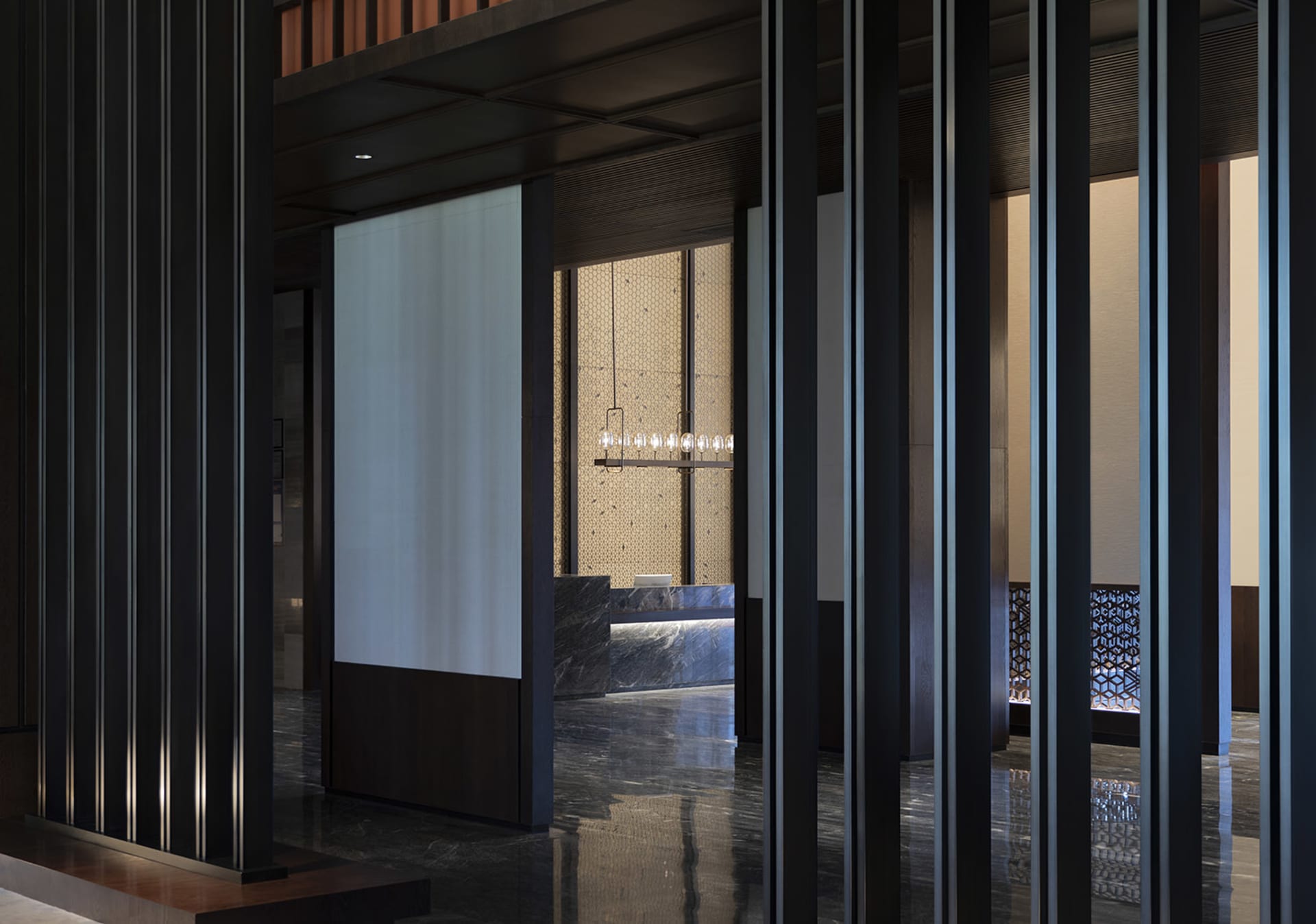 Modern hotel reception with metallic columns and marble flooring