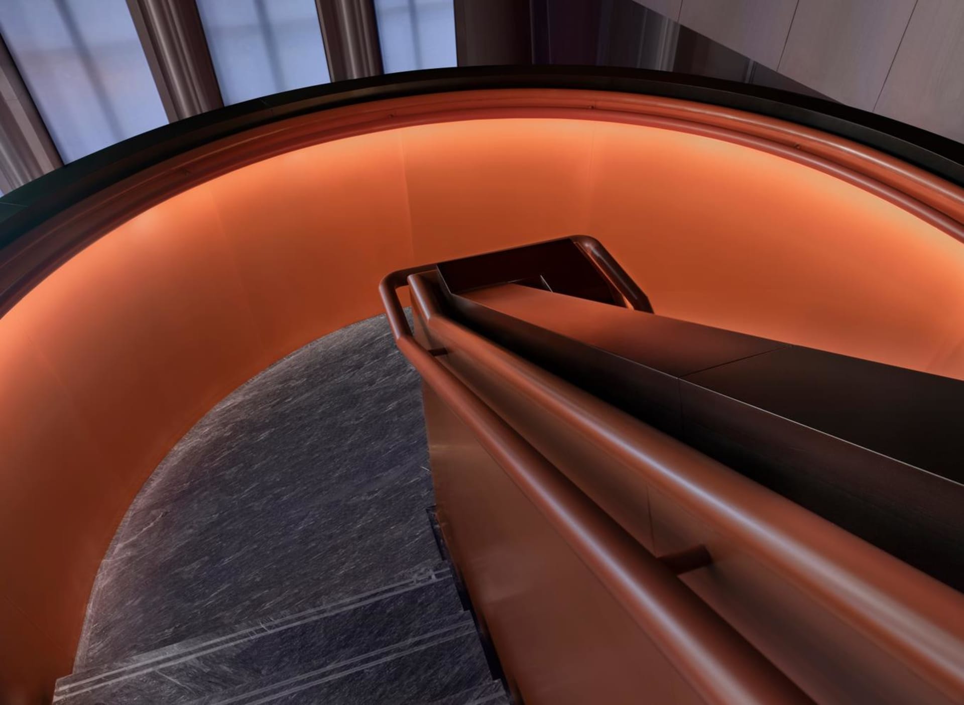 Modern metal staircase with orange lighting