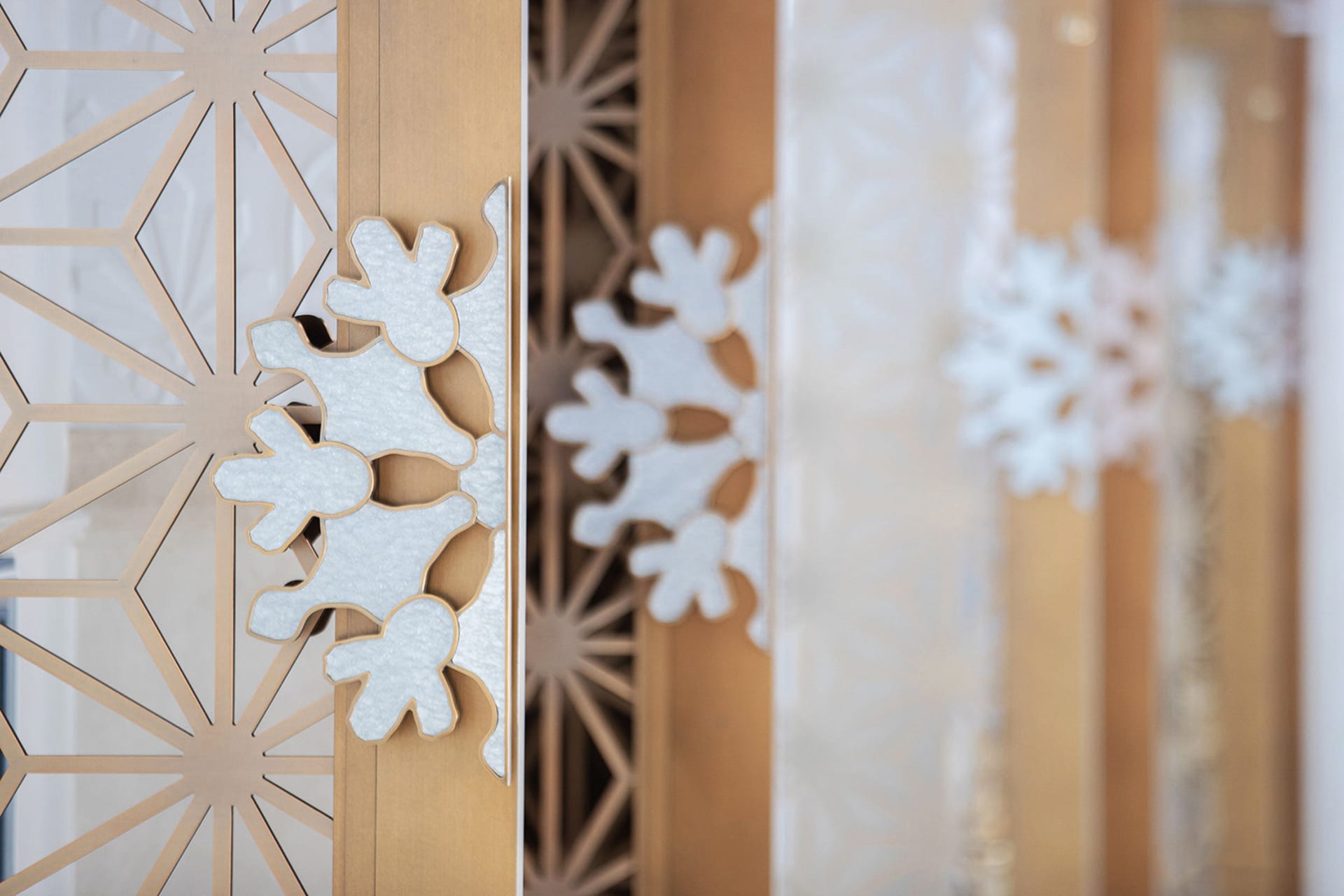 Close-up image of a decorative metal door handle adorned with glitter elements.