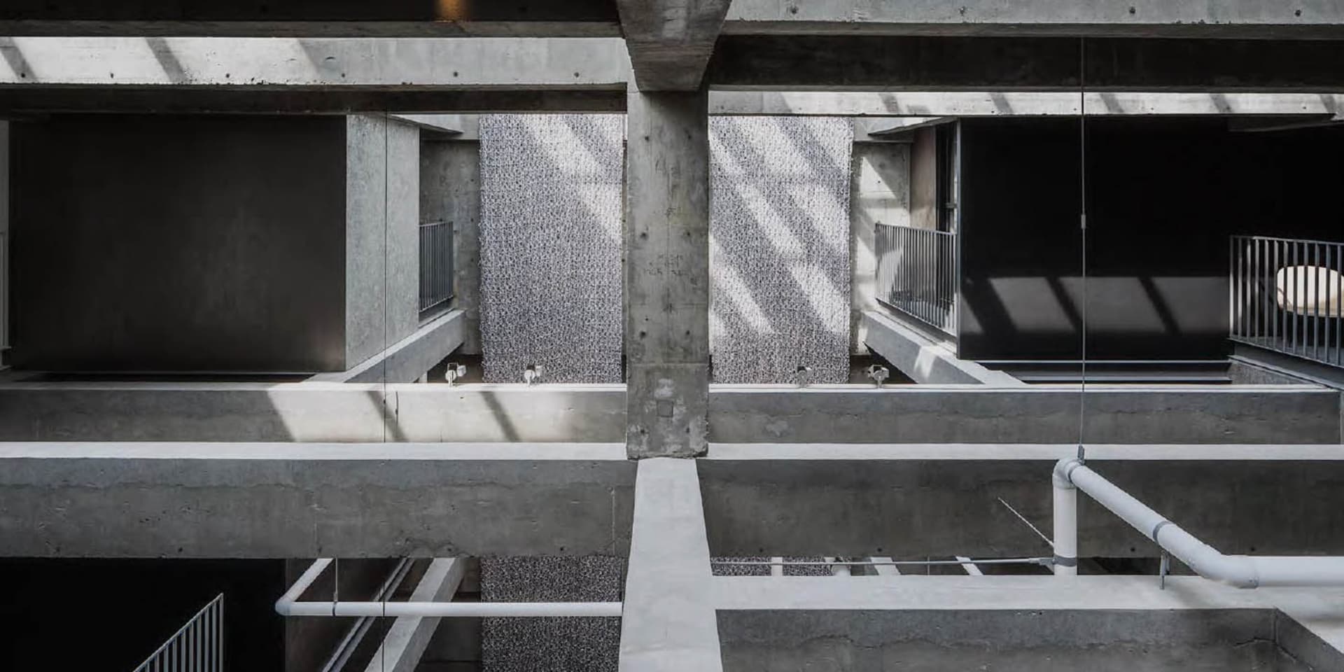 An overhead view of a minimalist office space with concrete walls and floors.
