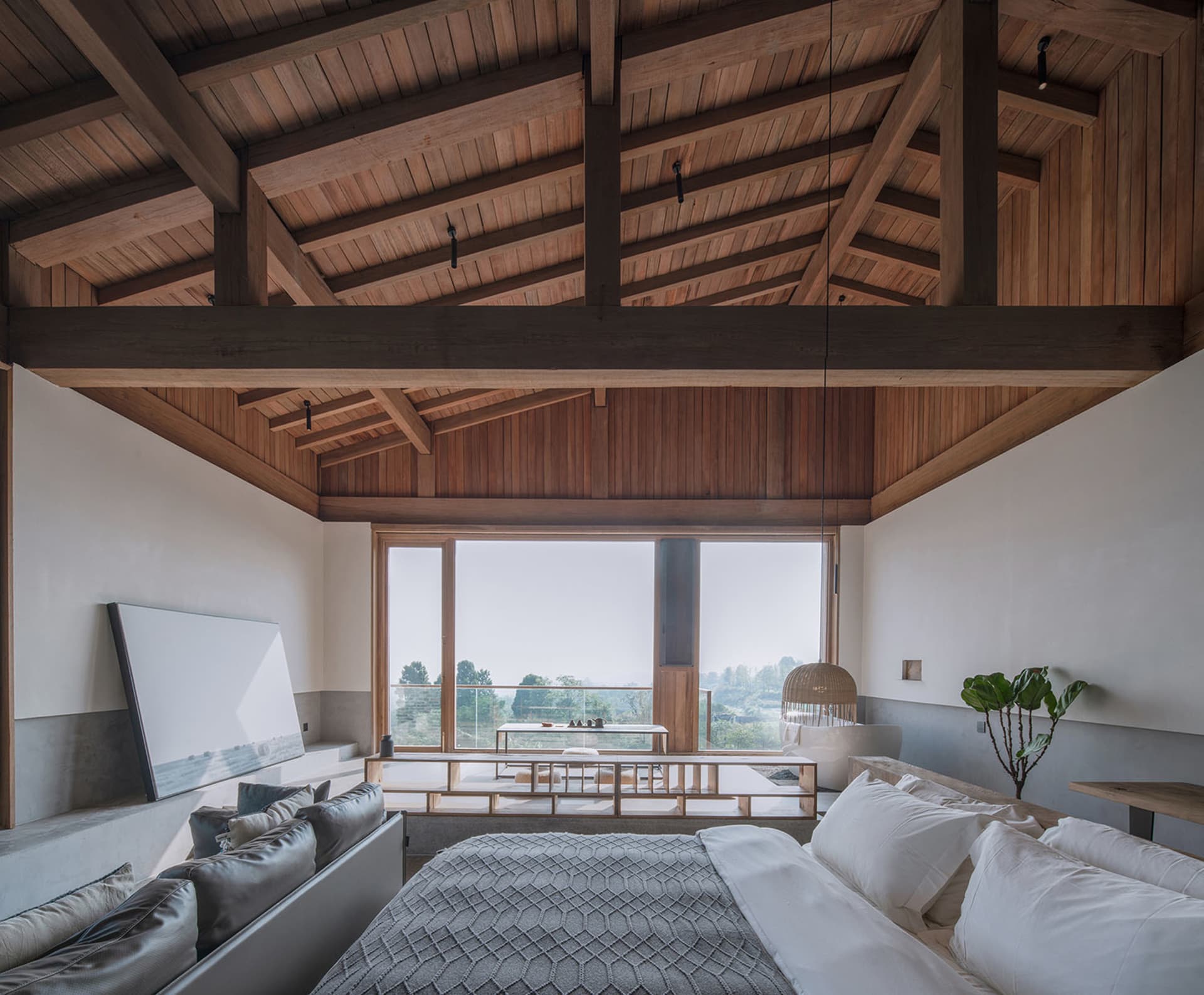 A minimalist bedroom featuring wooden furniture and a large window overlooking nature.