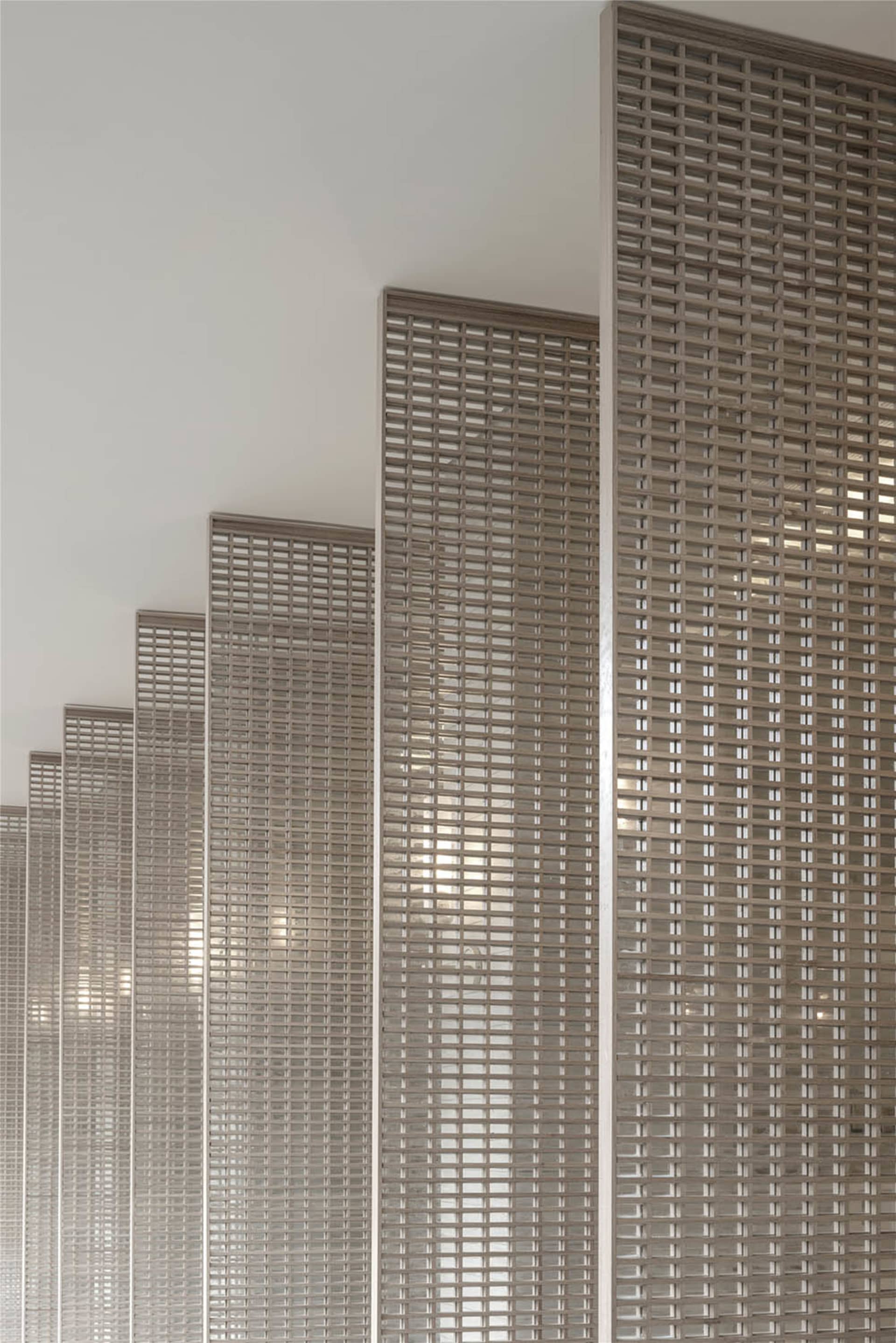 Modern interior design featuring a metal grid wall panel.