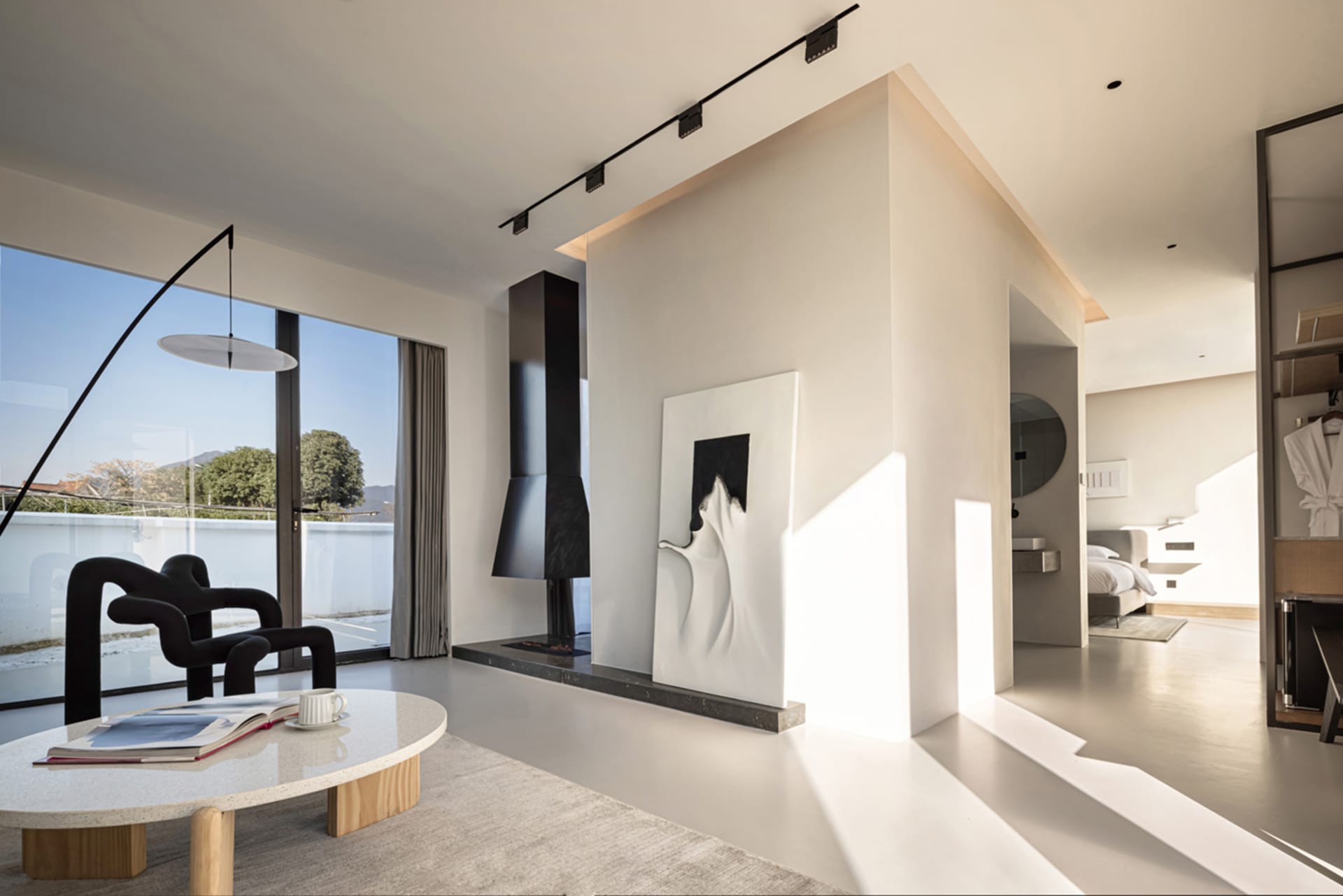 Modern living room with concrete elements and minimalistic design.